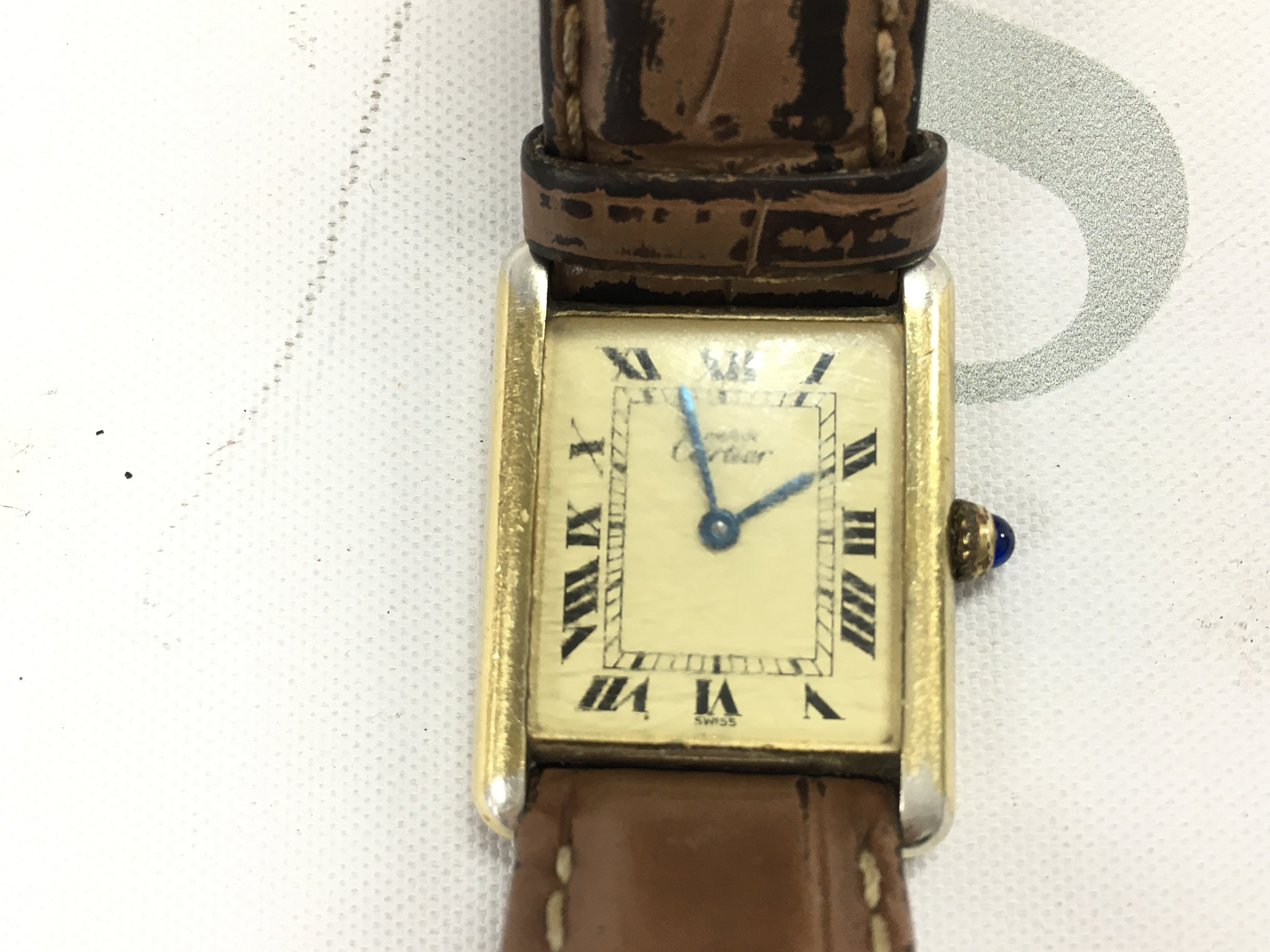 A vintage Cartier Tank must de watch. On replacement strap. Comes with a box and booklet.