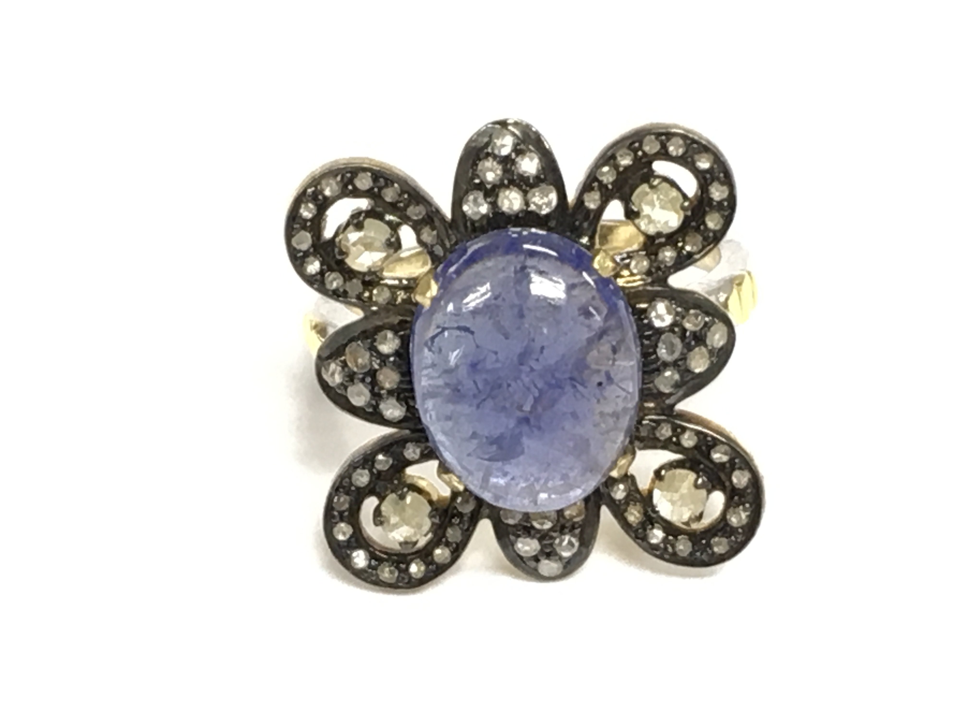 Silver gilt ornate dress ring set with an oval cabochon tanzanite and rose cut diamonds. Tanzanite 4.55ct and diamonds 0.74ct Approx. Size M