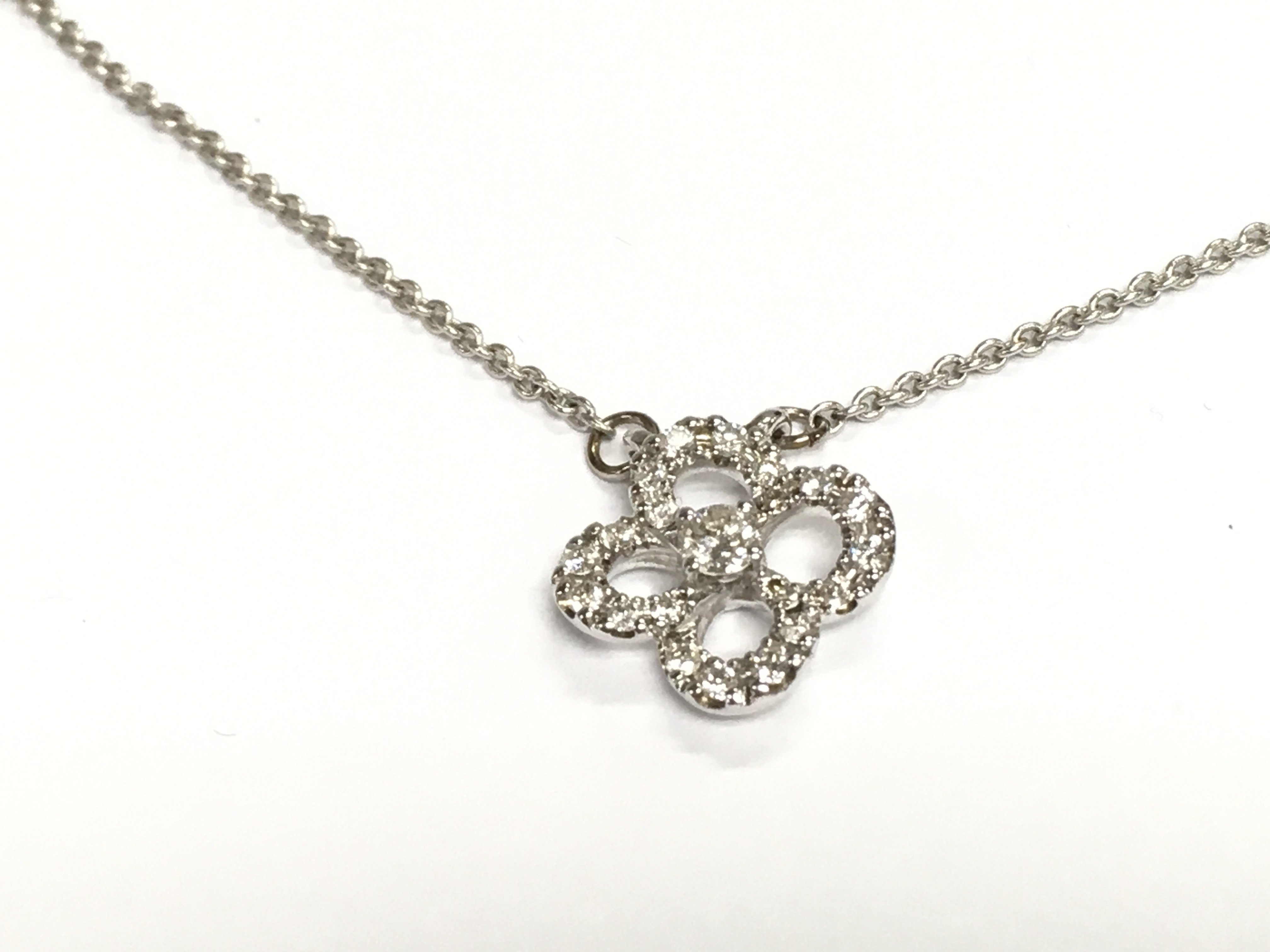 9ct white gold diamond set quatrefoil style pendant with integral chain. Diamonds approx 0.40ct and 3.20g
