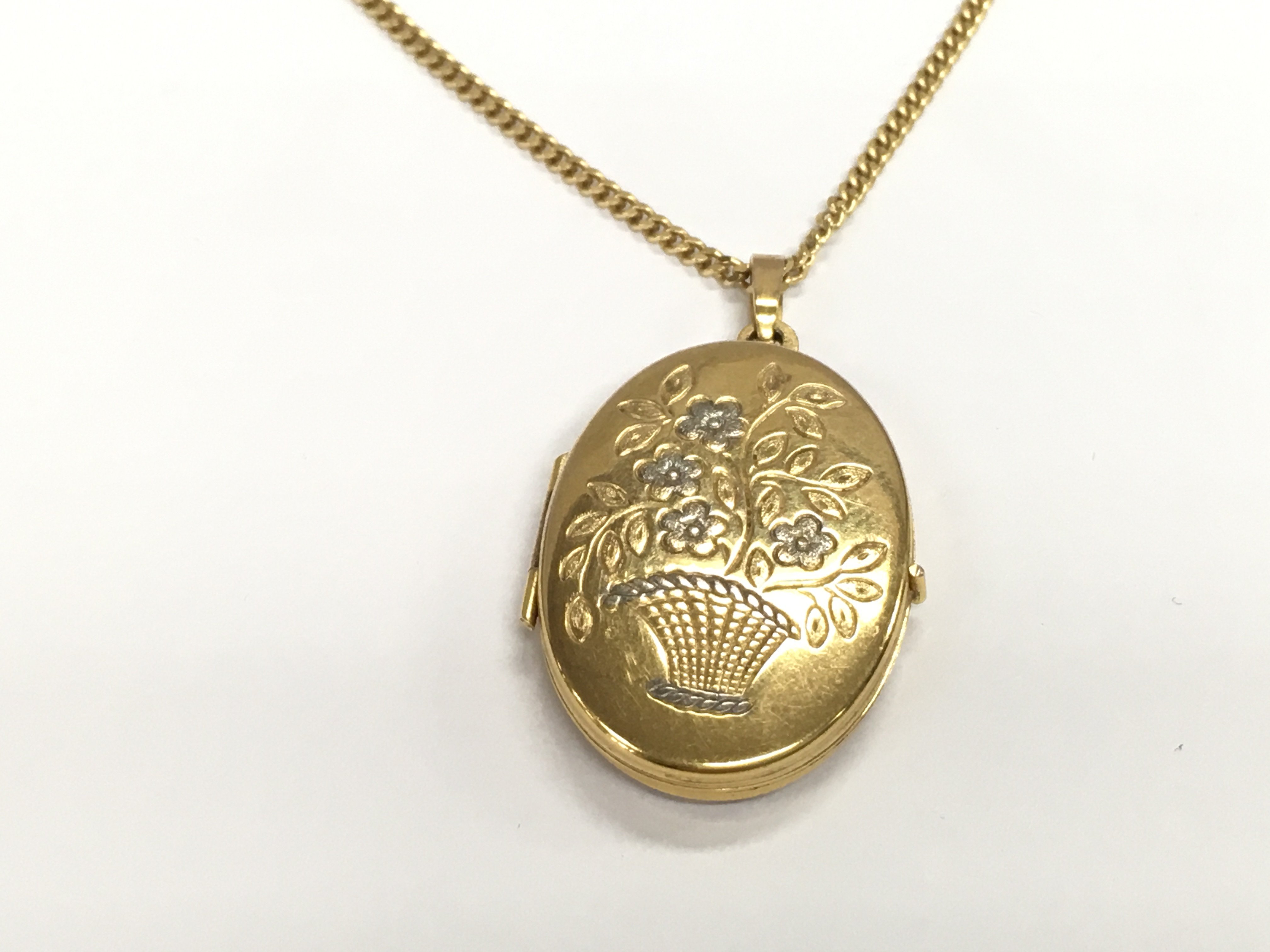 A 9ct gold locket and chain. Total weight 9.19g