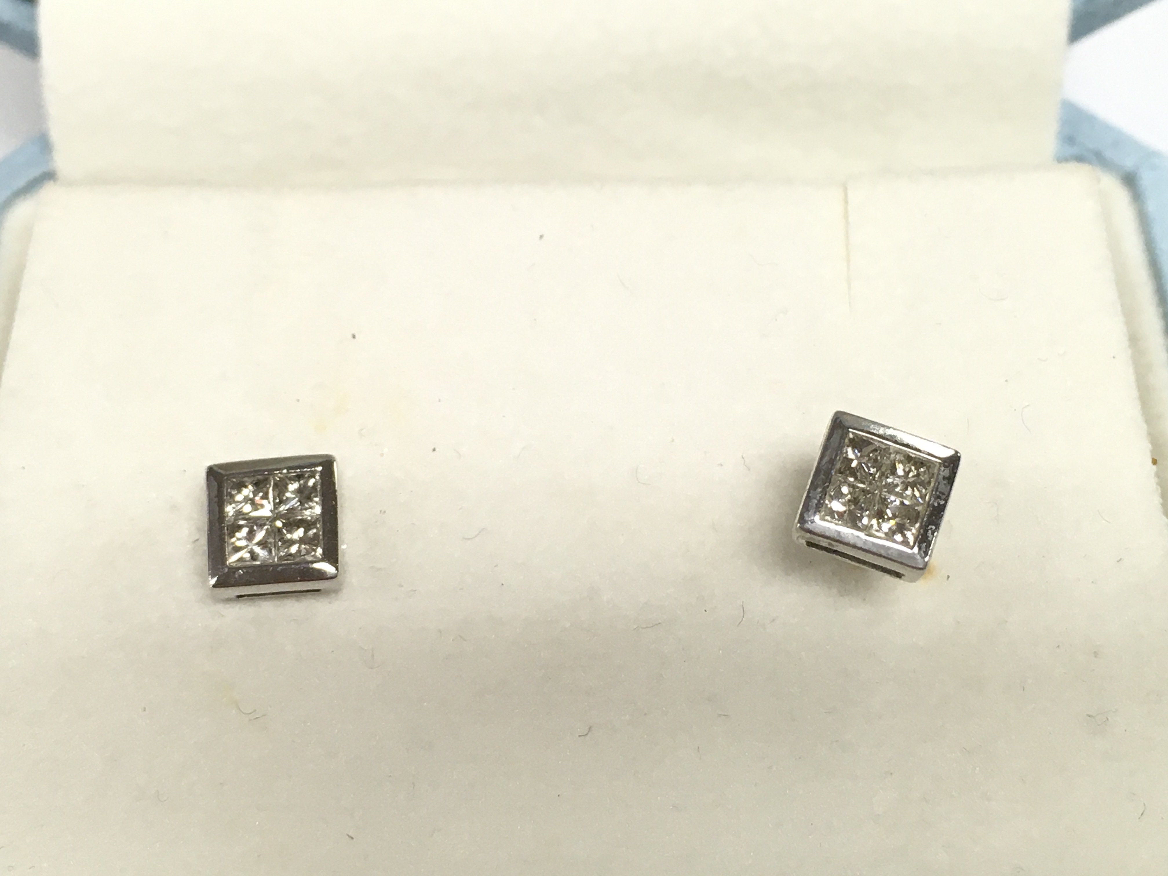 A pair of 9ct white gold illusion Princess cut studs.