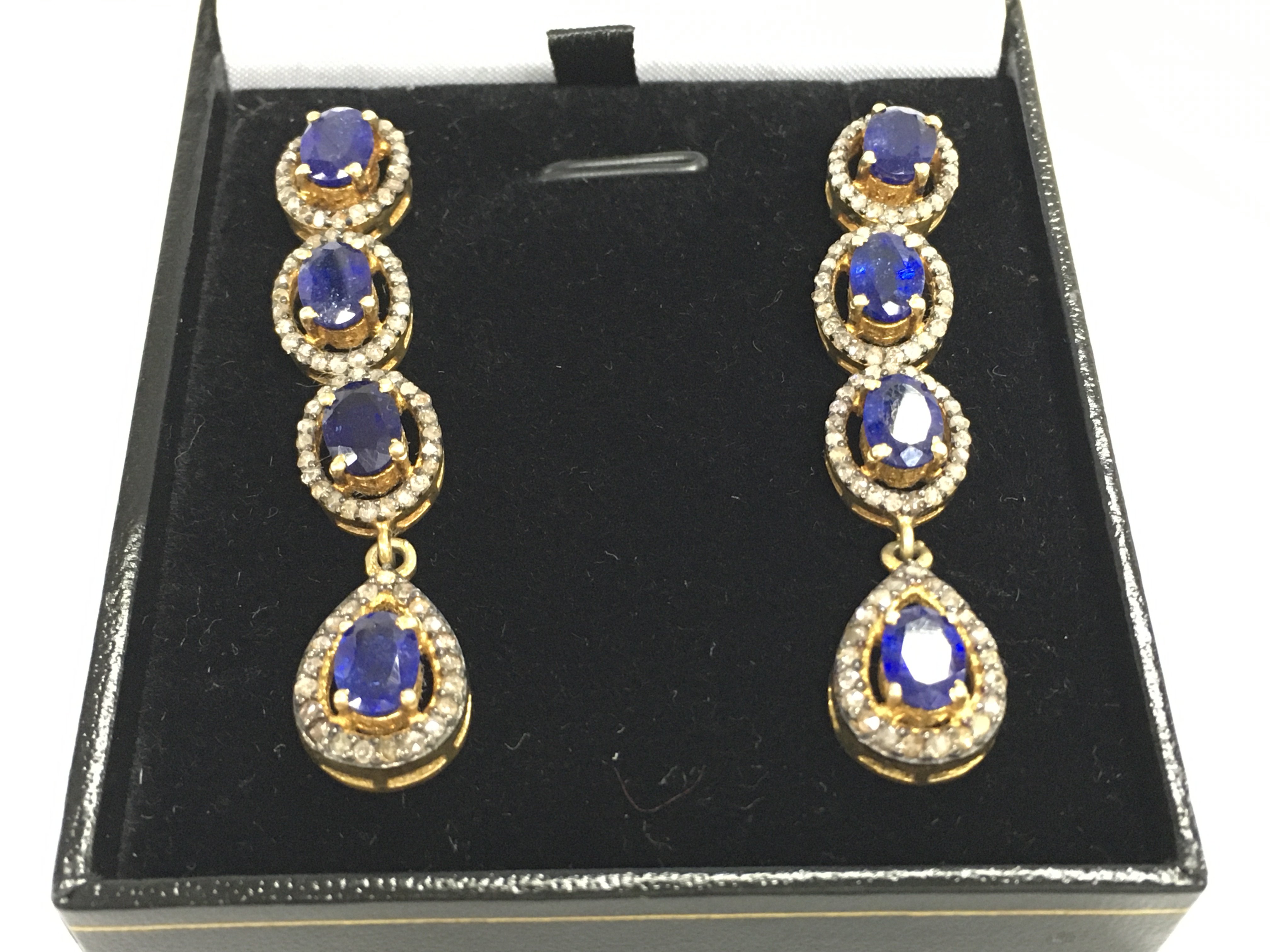 A pair of silver gilt long drop earrings set with oval kyanites each surrounded by diamonds. Kyanites 5ct and 1.65ct diamonds approx