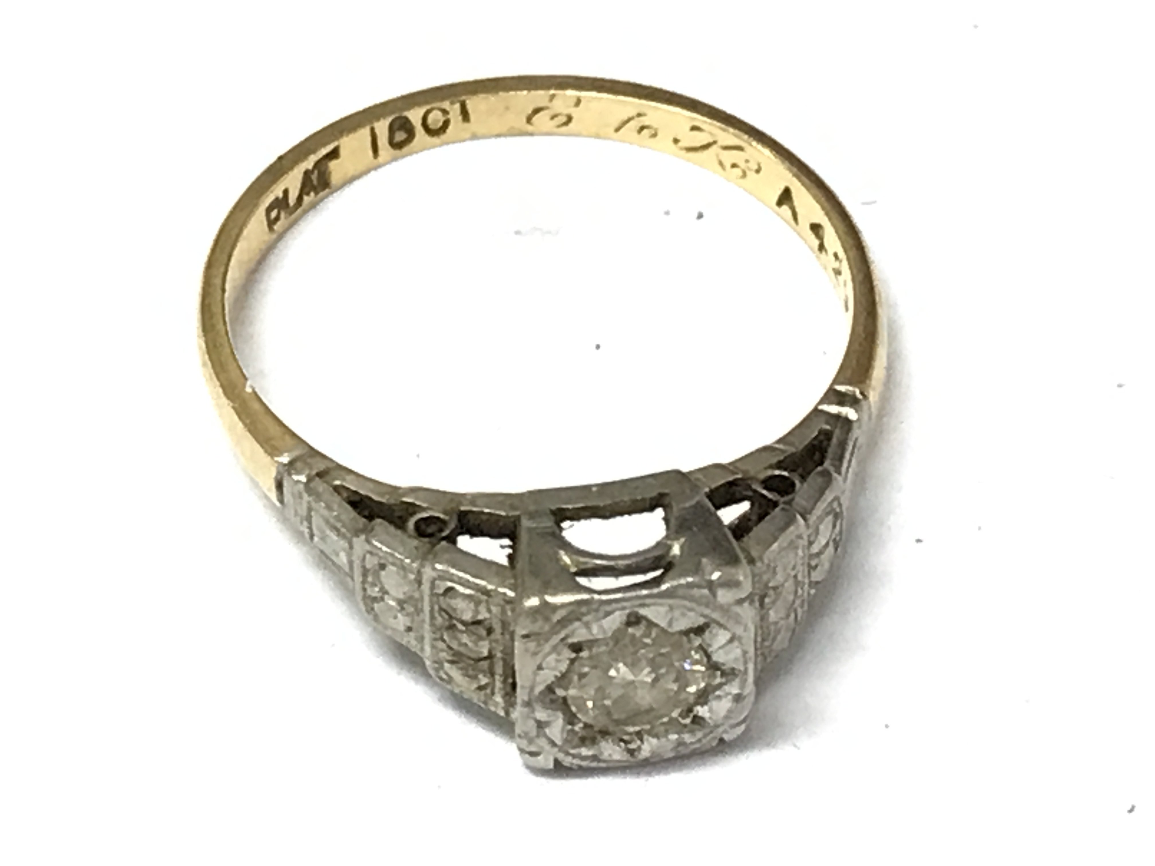 An 18ct gold and platinum ring, approximately 0.25ct. Size N/O. 2.7g total weight Postage category A