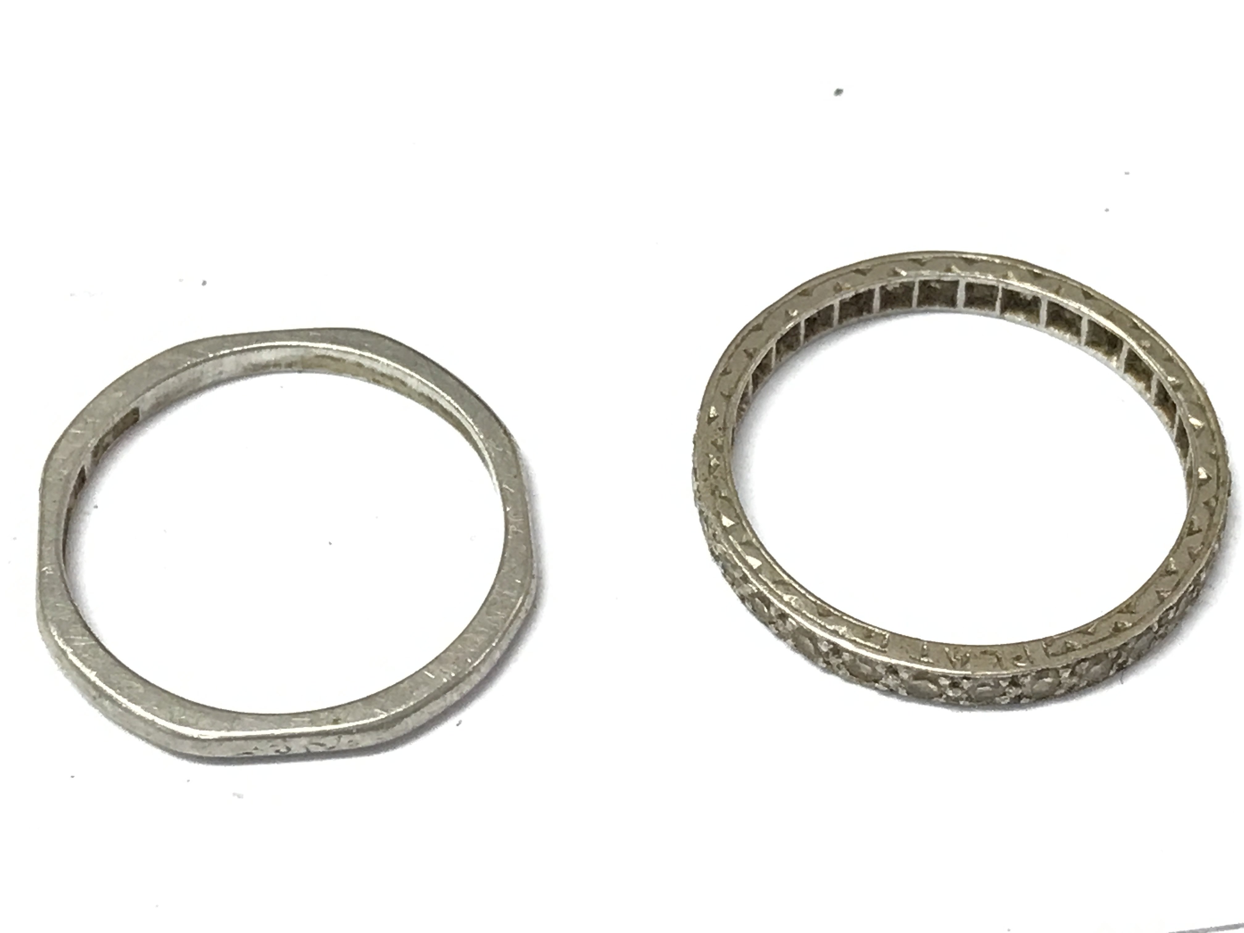Two platinum bands (one being an eternity ring). Size O & M. 4.9g total weight Postage category A