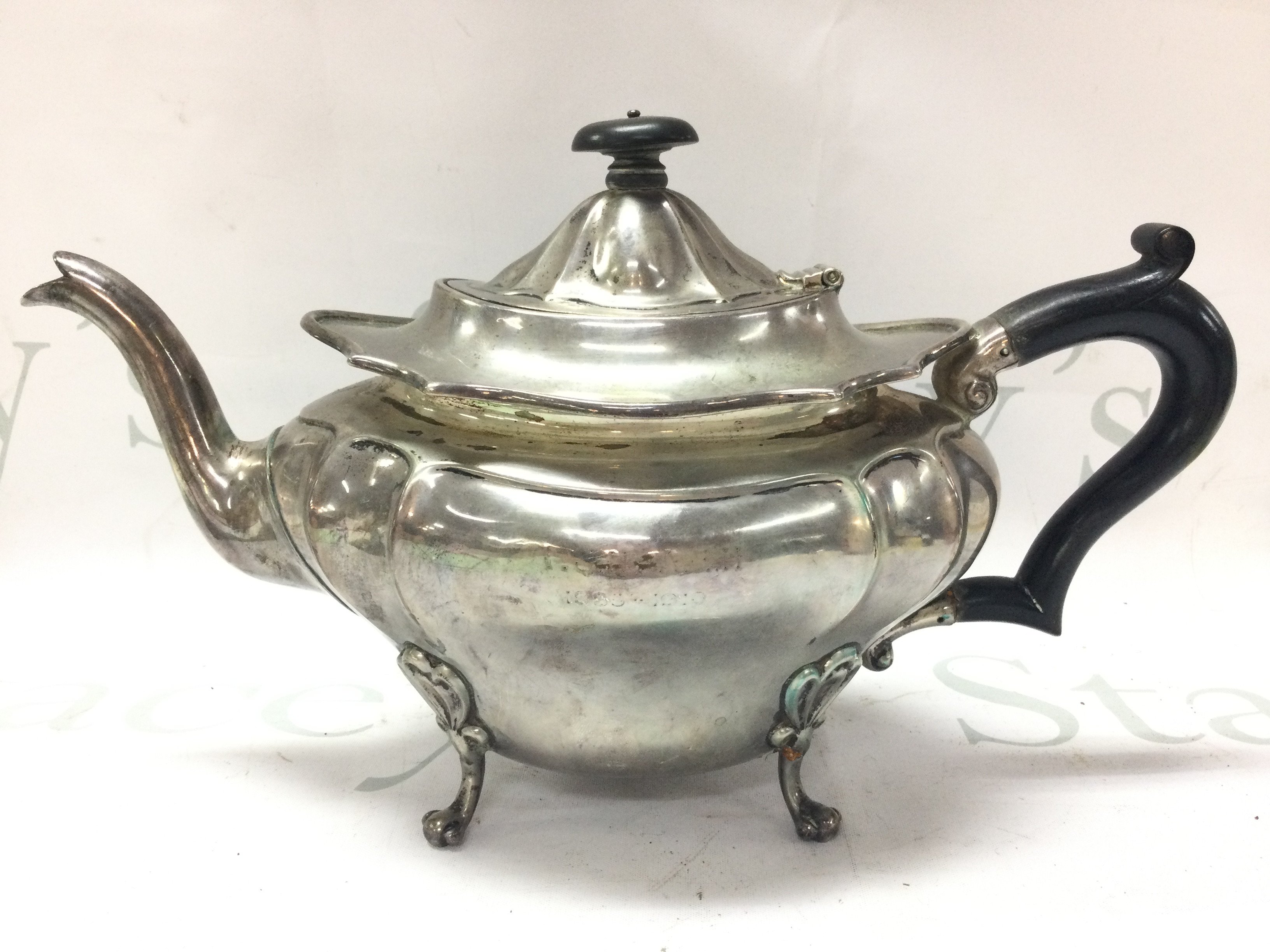 A silver hallmarked teapot with paw feet marked London 1910. Postage cat B