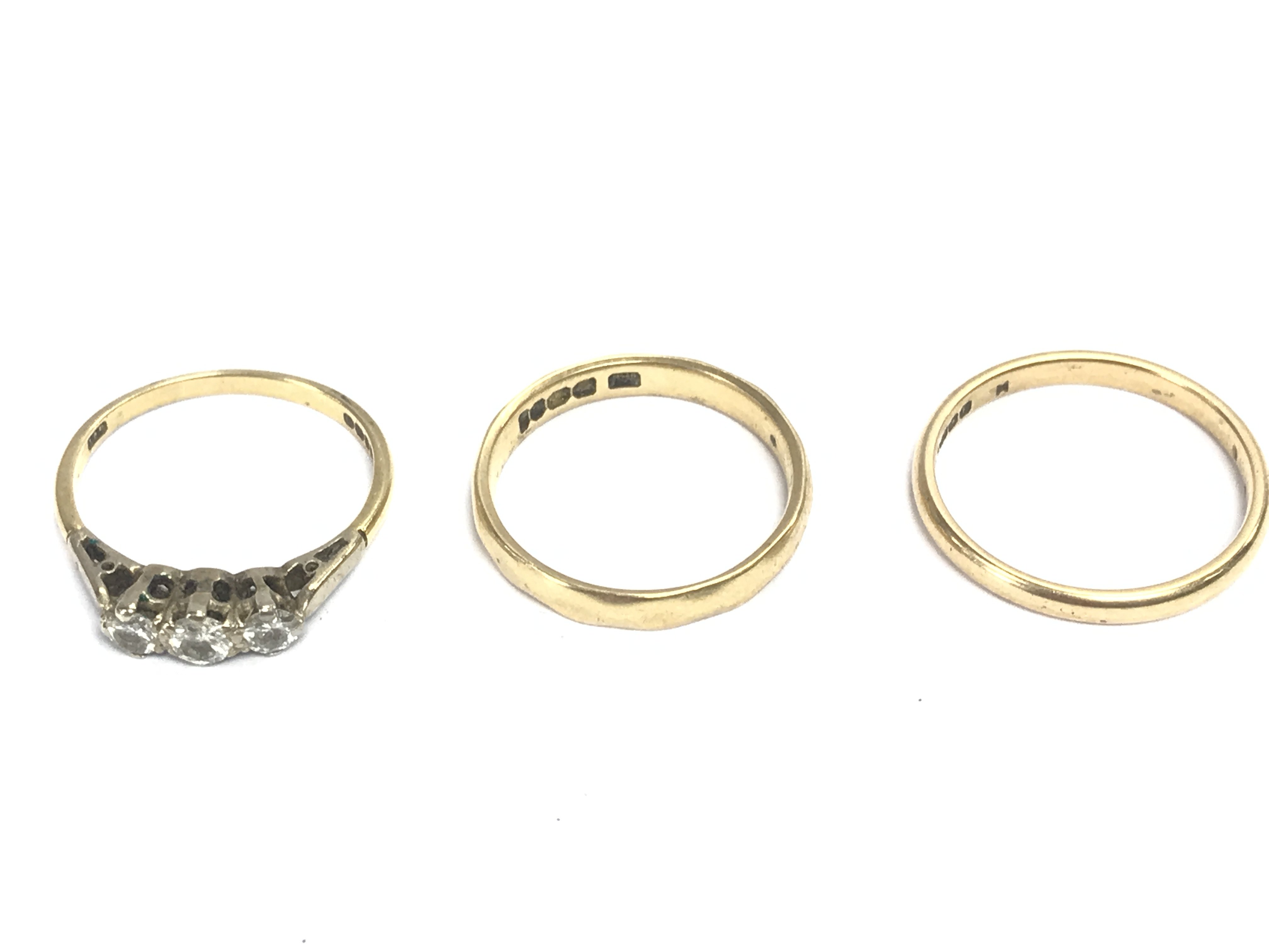 Two 18ct gold bands and an 18ct gold diamond set ring. 7.47g. Postage A