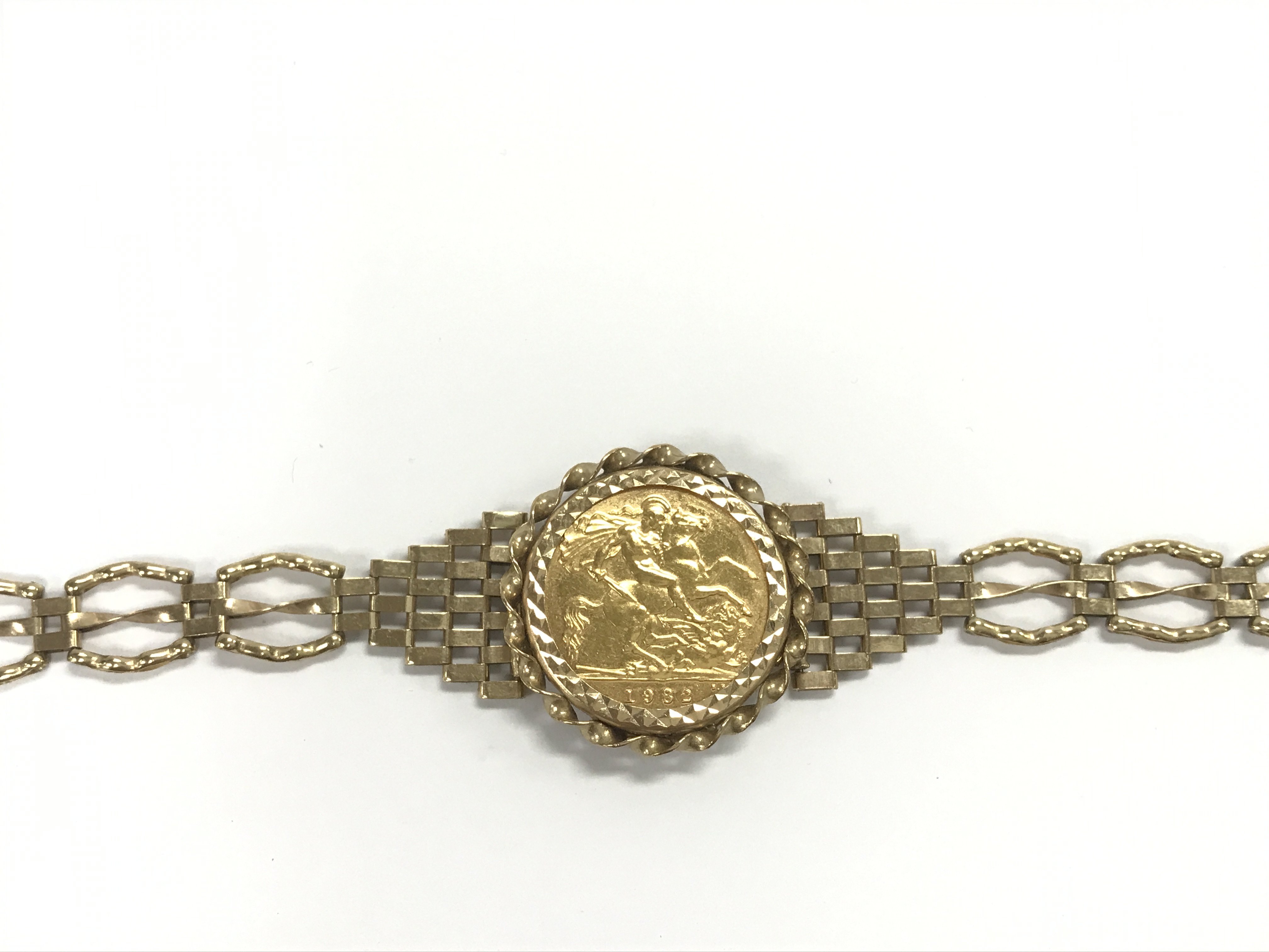 A 1982 half sovereign in a 9ct gold gate bracelet. 10.65g Postage A