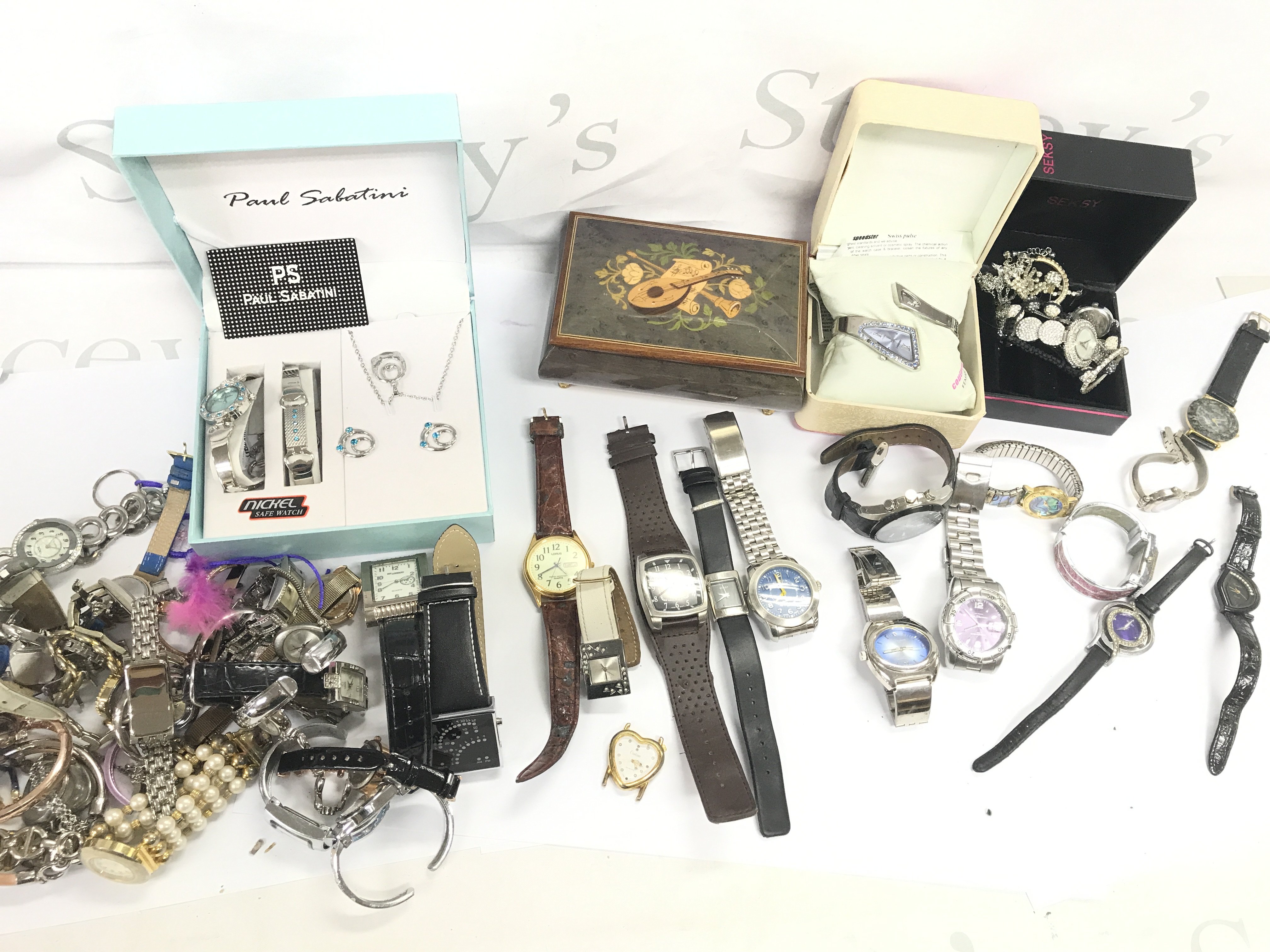 A large collection of assorted fashion watches including Ben Sherman and seksy etc Postage B