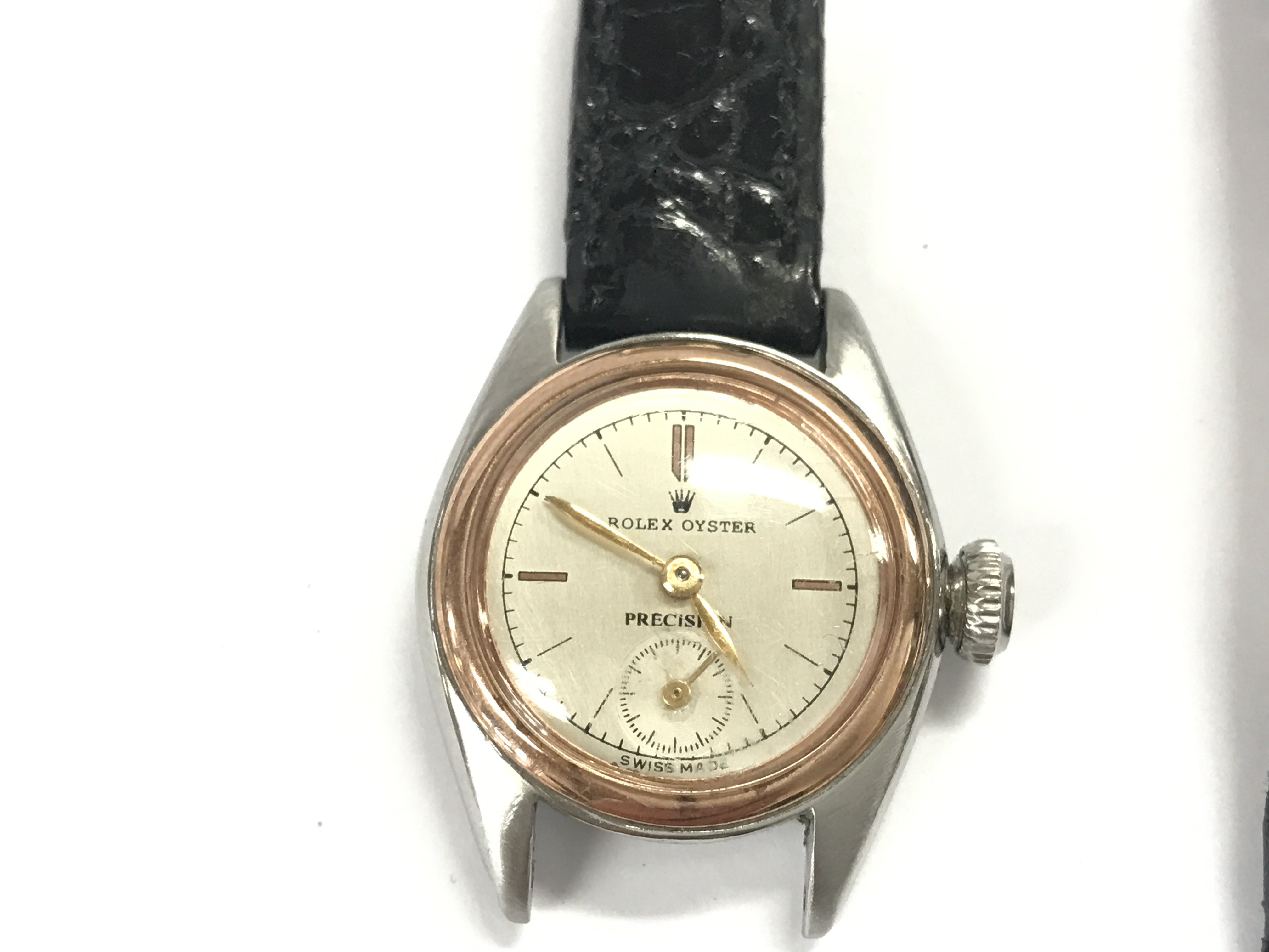 A vintage ladies Oyster Precision watch. Approximately 24mm case. Black leather strap. Comes with aftermarket box. Not seen running.