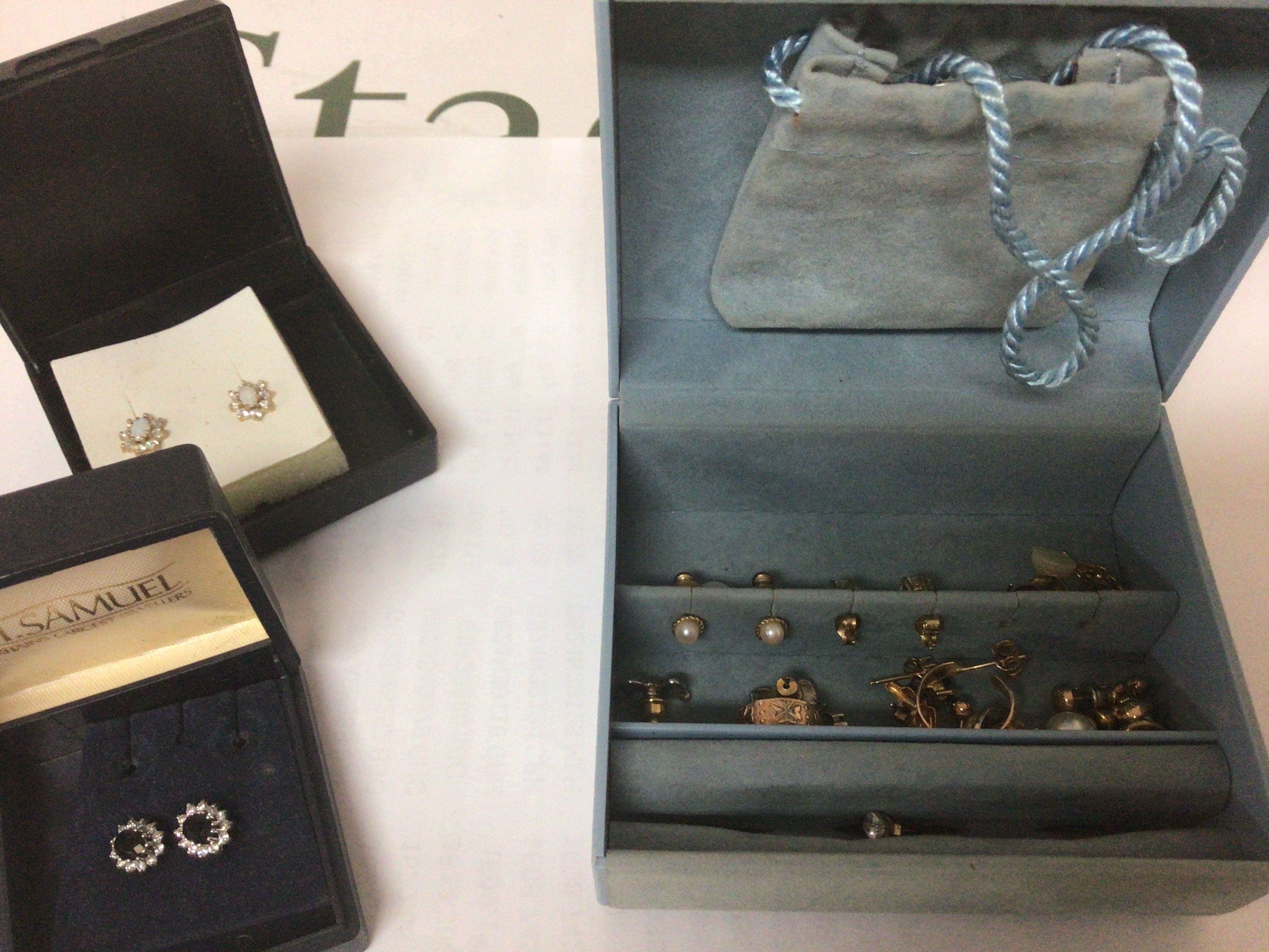 A collection of gold and other earrings set with pearls and other stones.