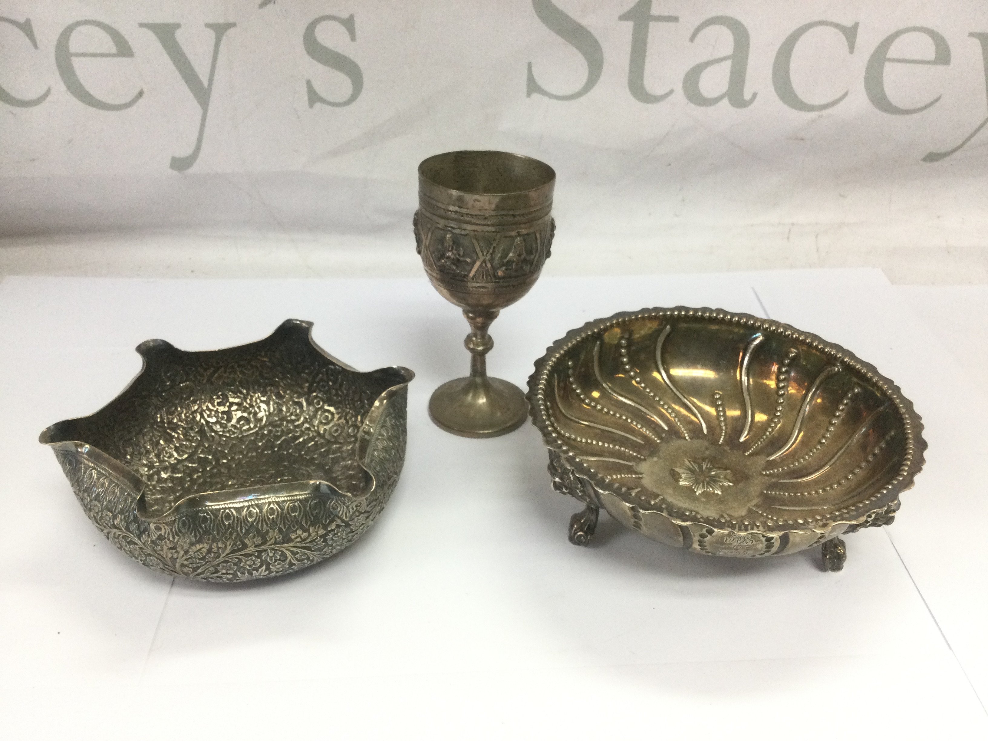 Three pieces of Indian and Persian silver comprising two bowls and a small goblet. Shipping category B.