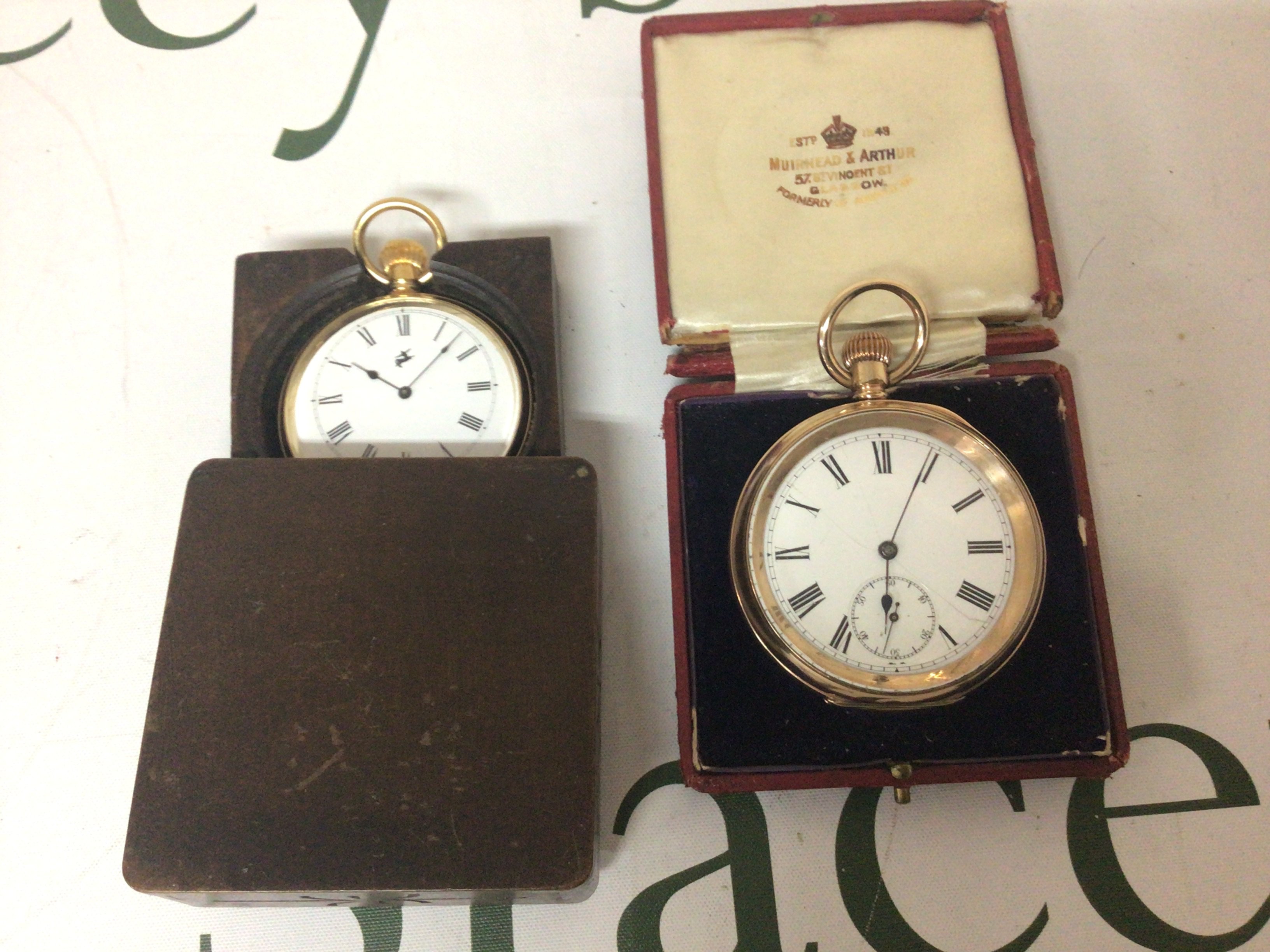 A Gold plated pocket watch with an enamel dial working and one other gold plated pocket watch in a continental carved wood case not seen working (2)