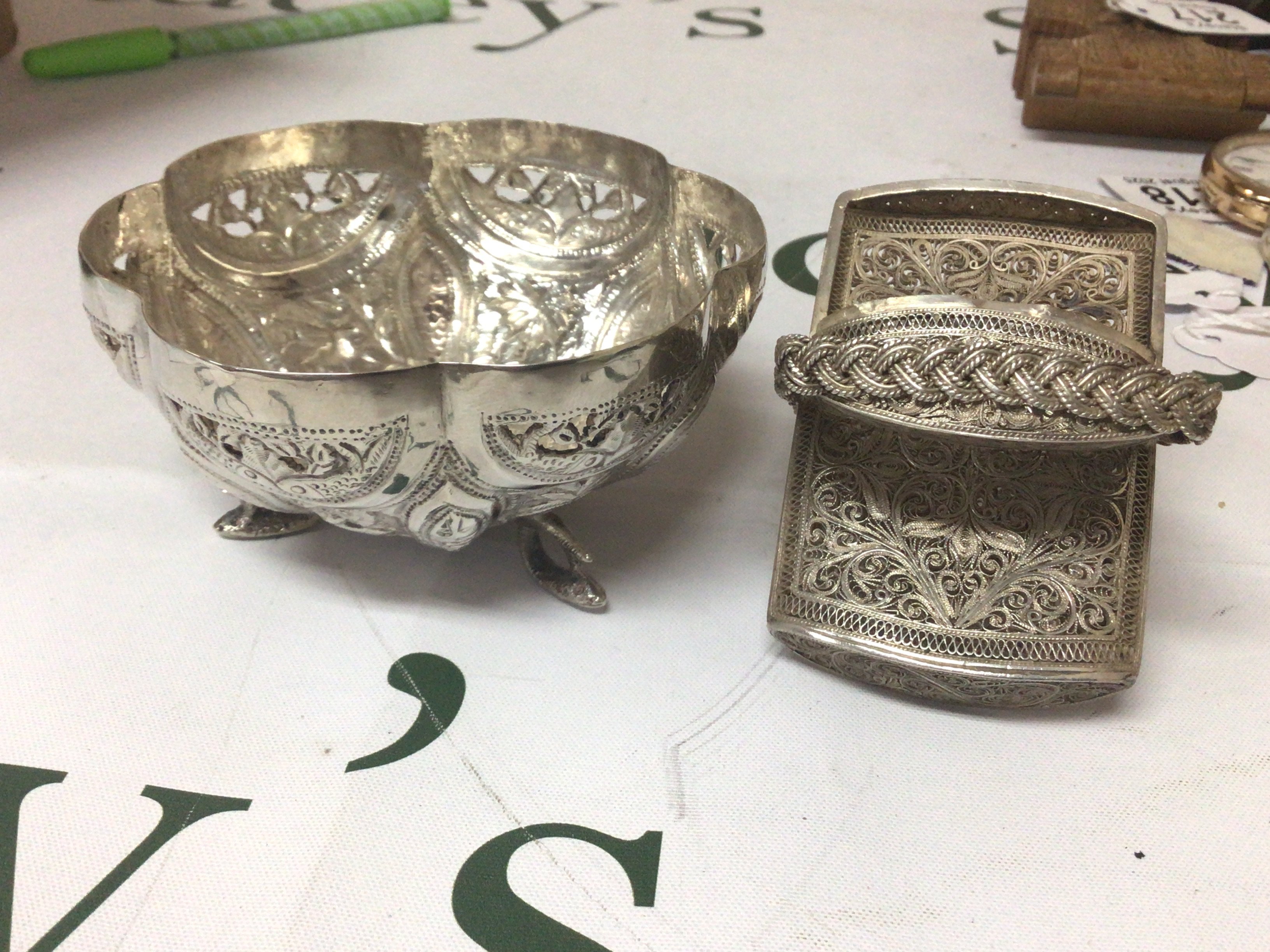 A white metal bowl stamped 90 possible Indian with Repousse decoration panels of animals and foliage. and a filigree case (2)