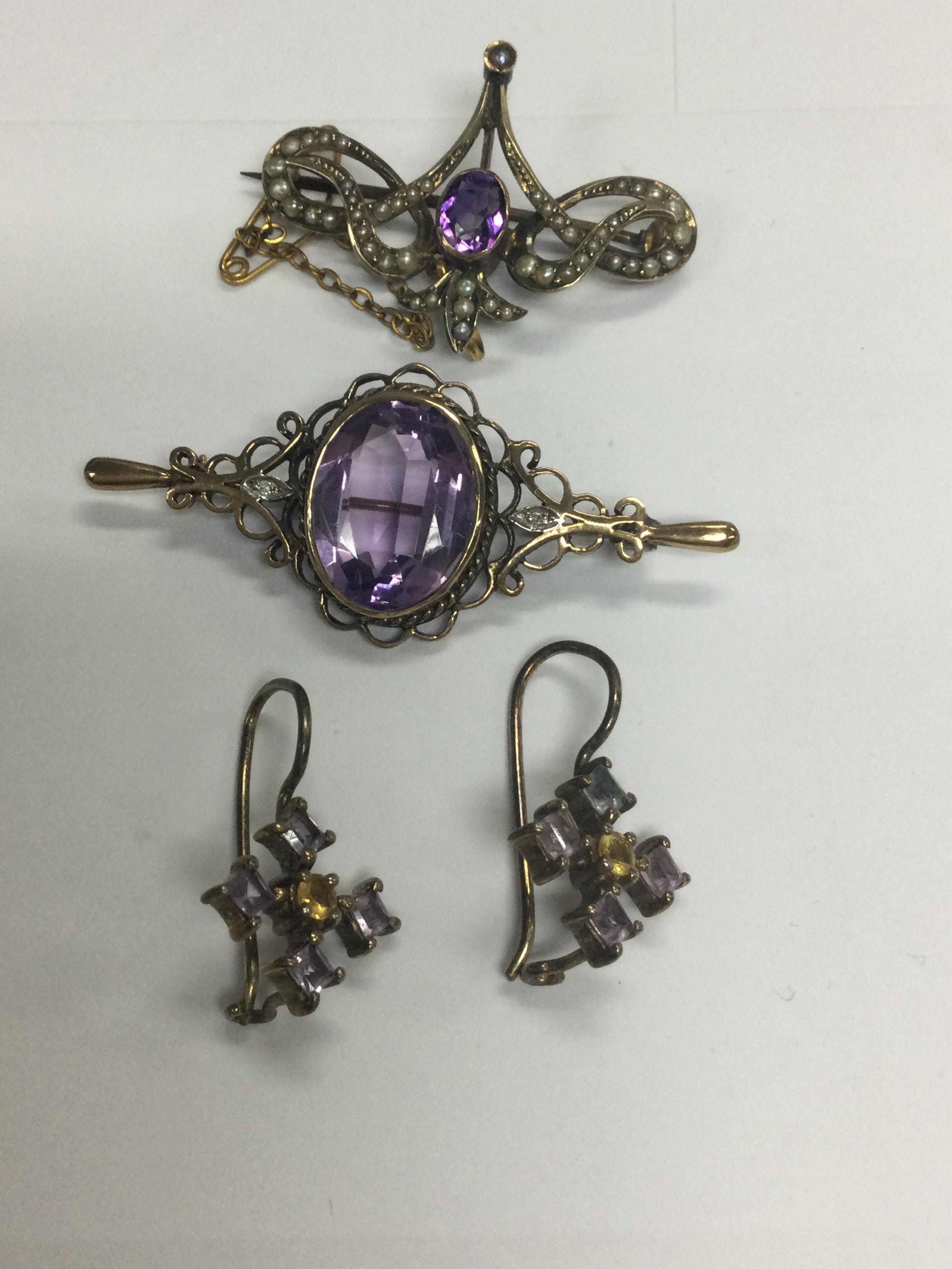 Two 9 ct gold brooches inset with Amethyst and a pair of ea