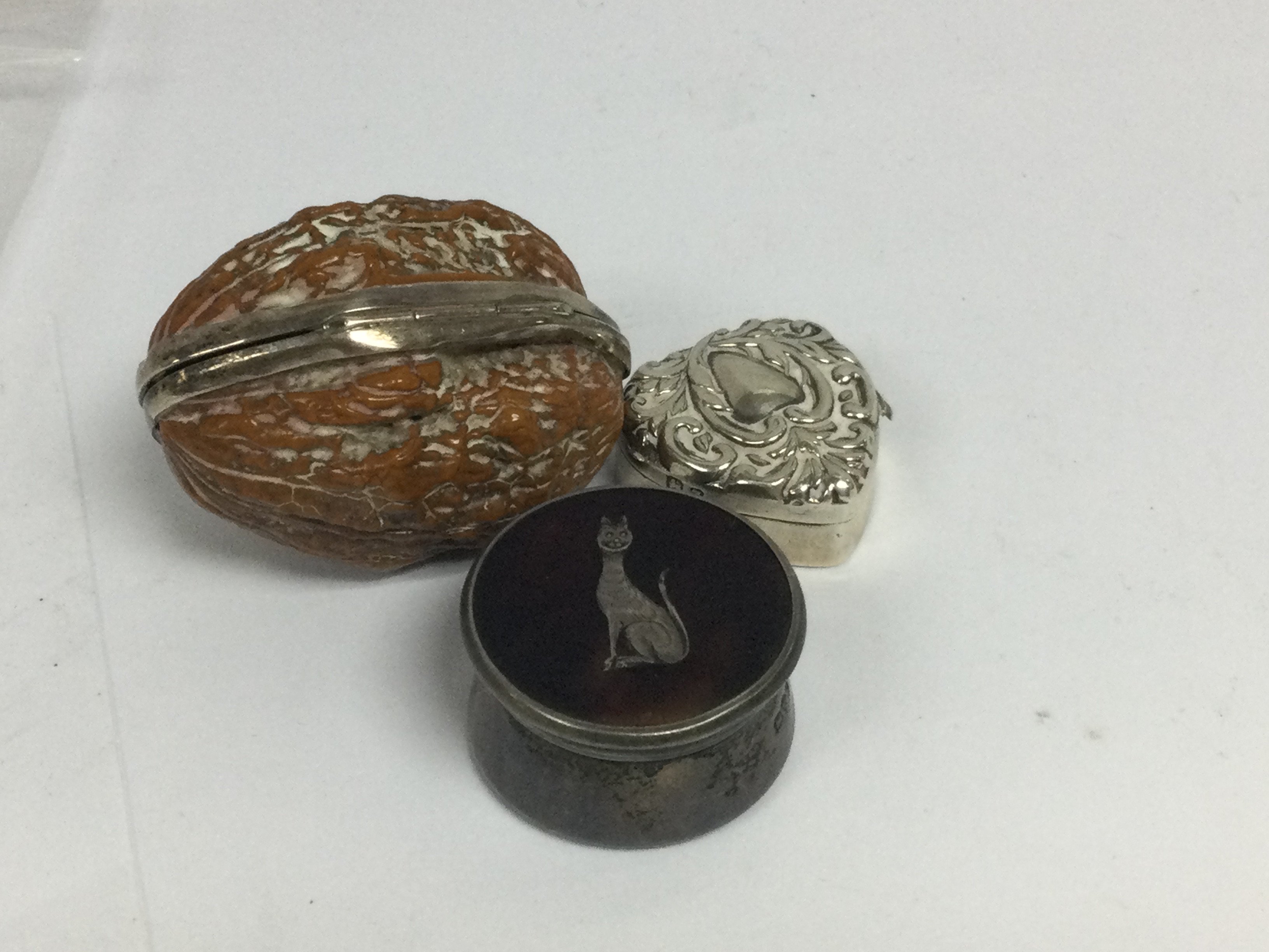 Three pill boxes including silver.