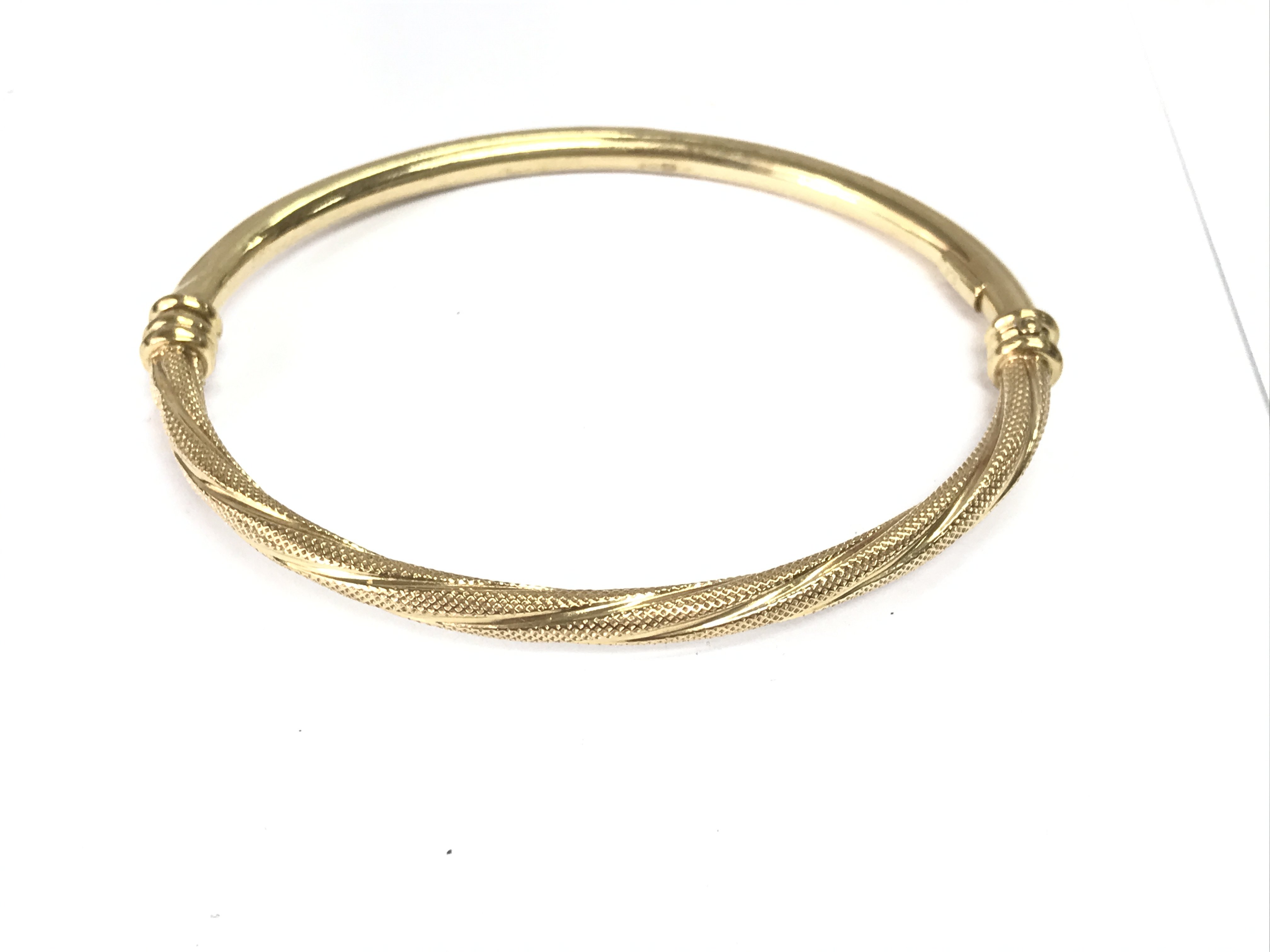 A 9ct gold bangle. 5.10g