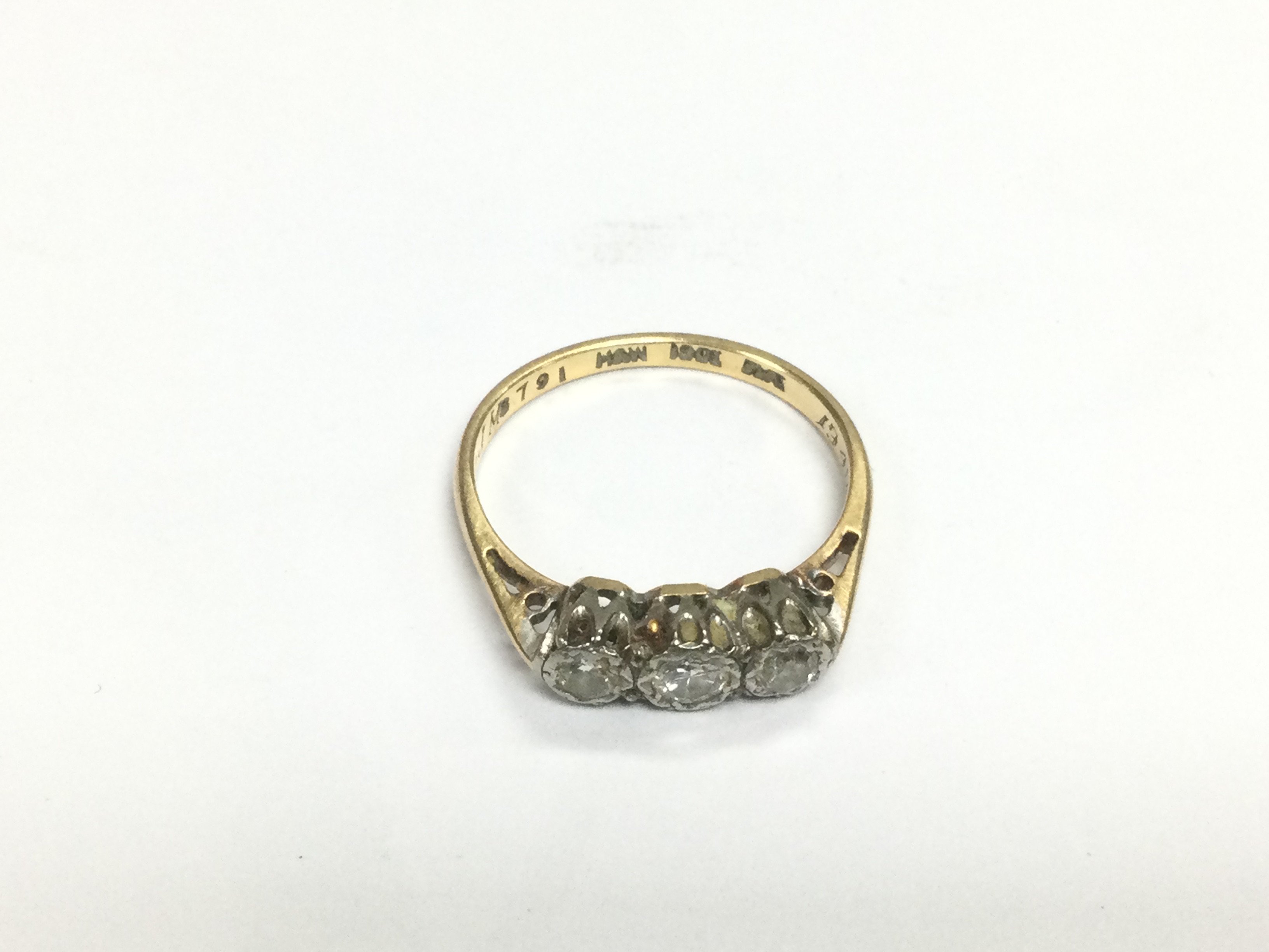 An 18ct gold ring set with three small diamonds, approx 2.3g and approx size N. Shipping category A.