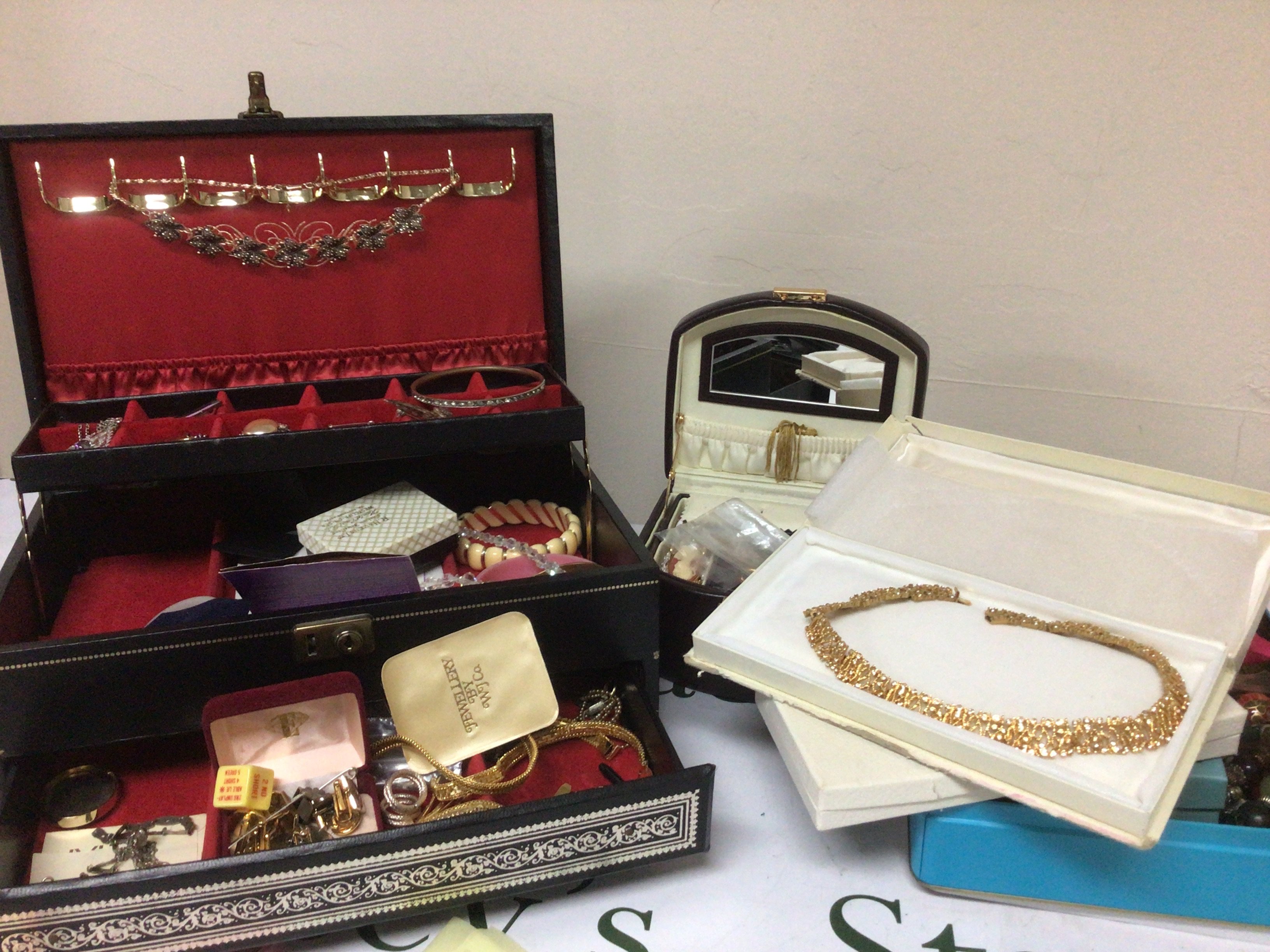 A collection of Costume jewellery including some silver in two jewellery boxes tin and other boxes.