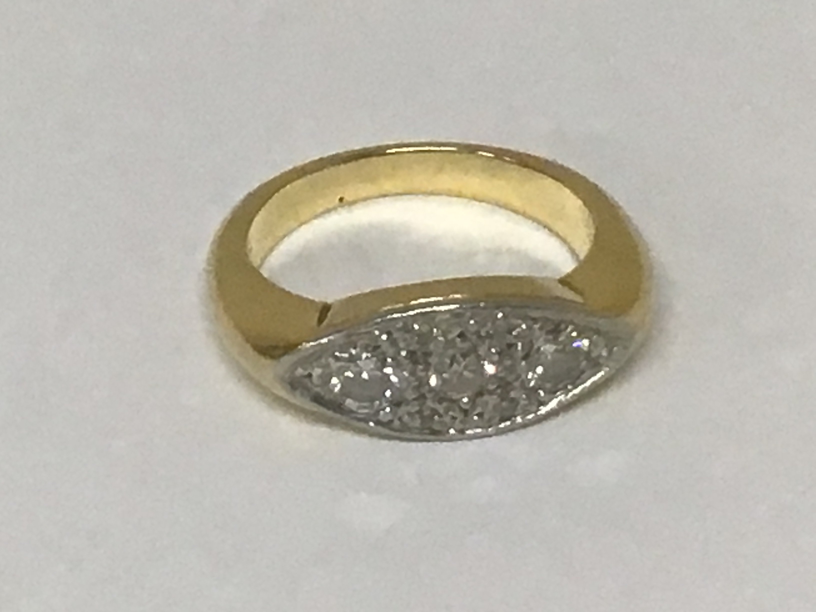 An unmarked ring set with a pattern of diamonds weight 8.3 grams.