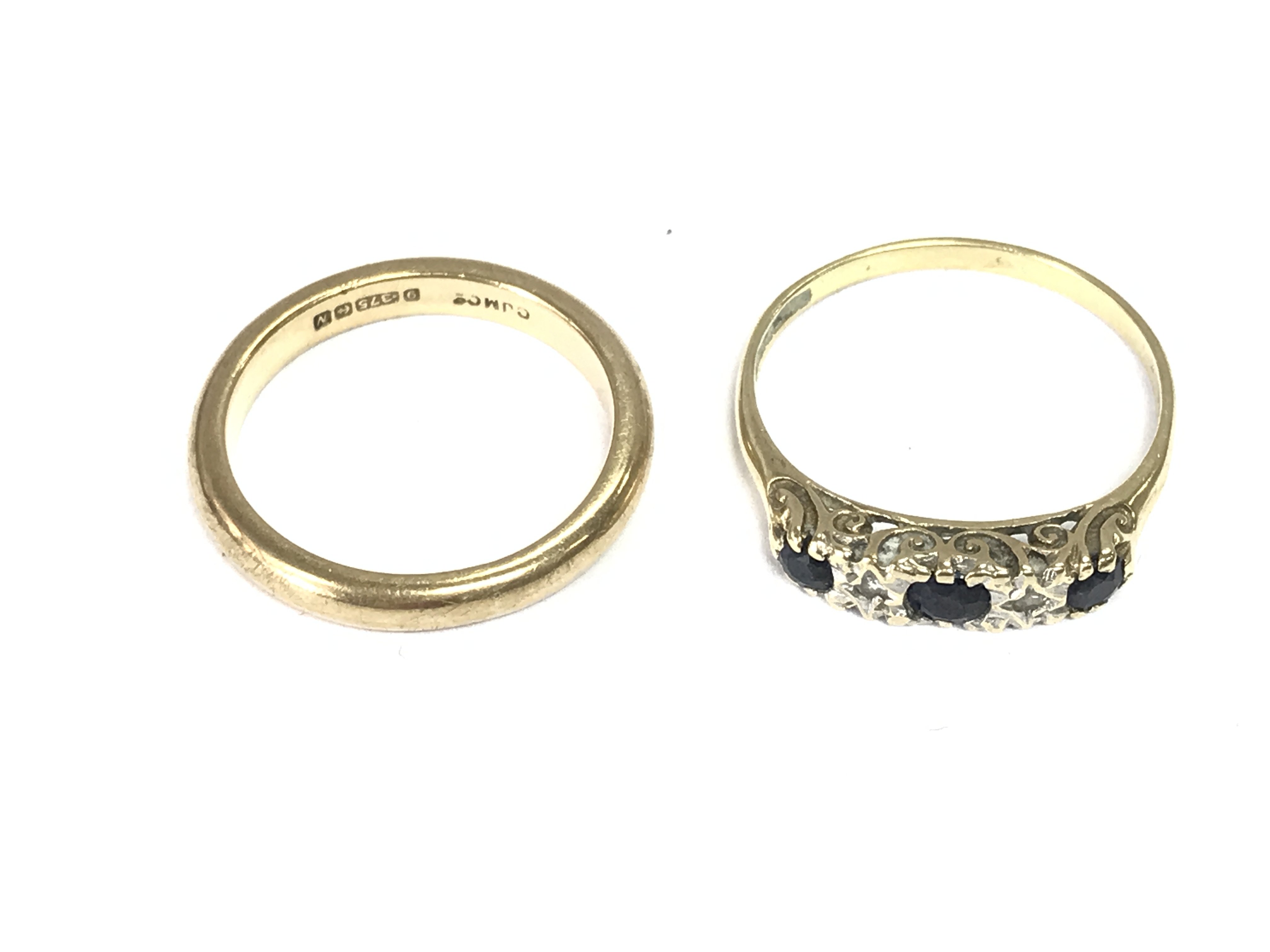 Two 9ct gold rings including a 9ct gold band. Size M and O. 4.80g Postage A