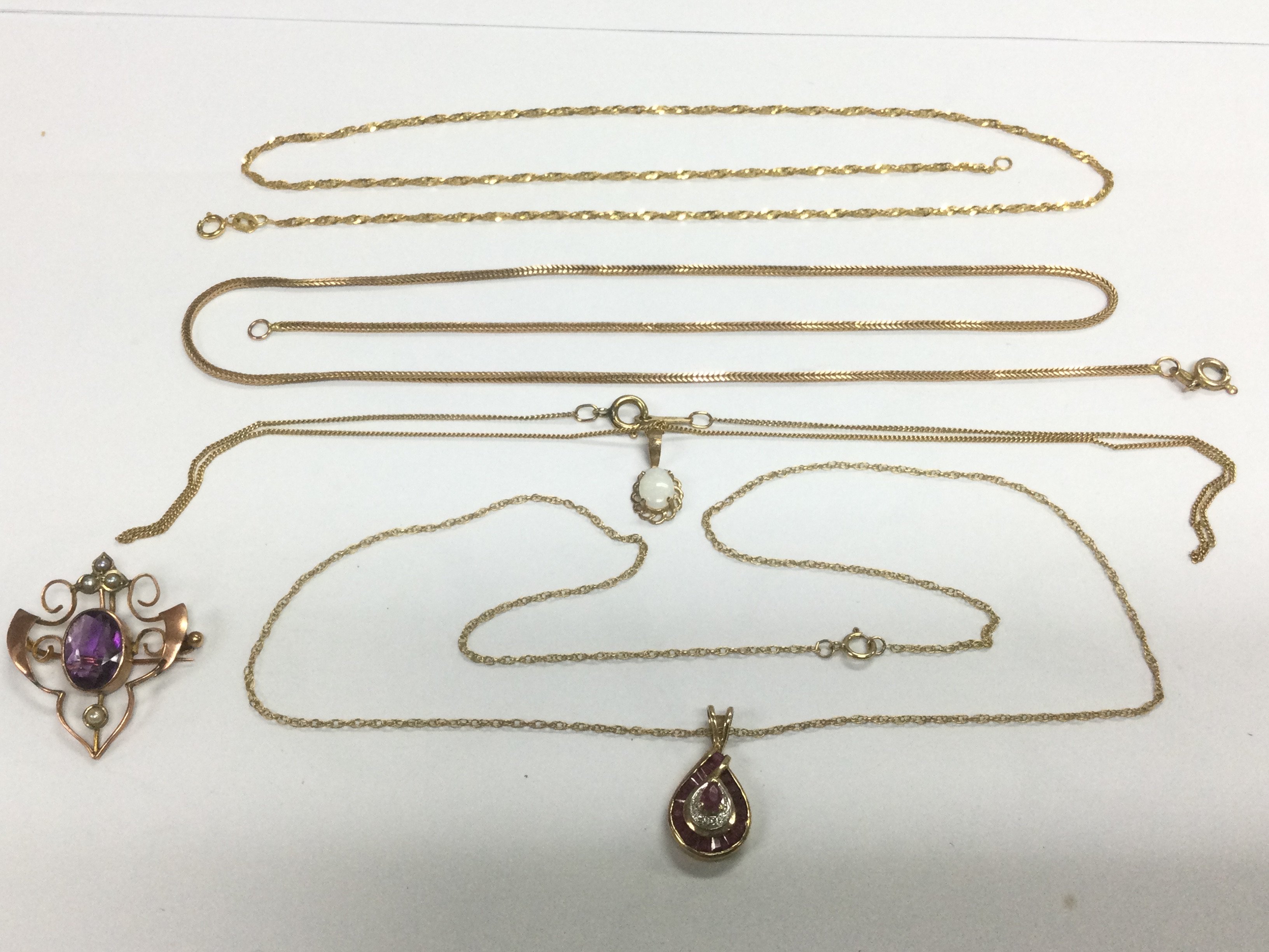 A collection of gold necklaces and pendants, approx 12.5g. Shipping category A.