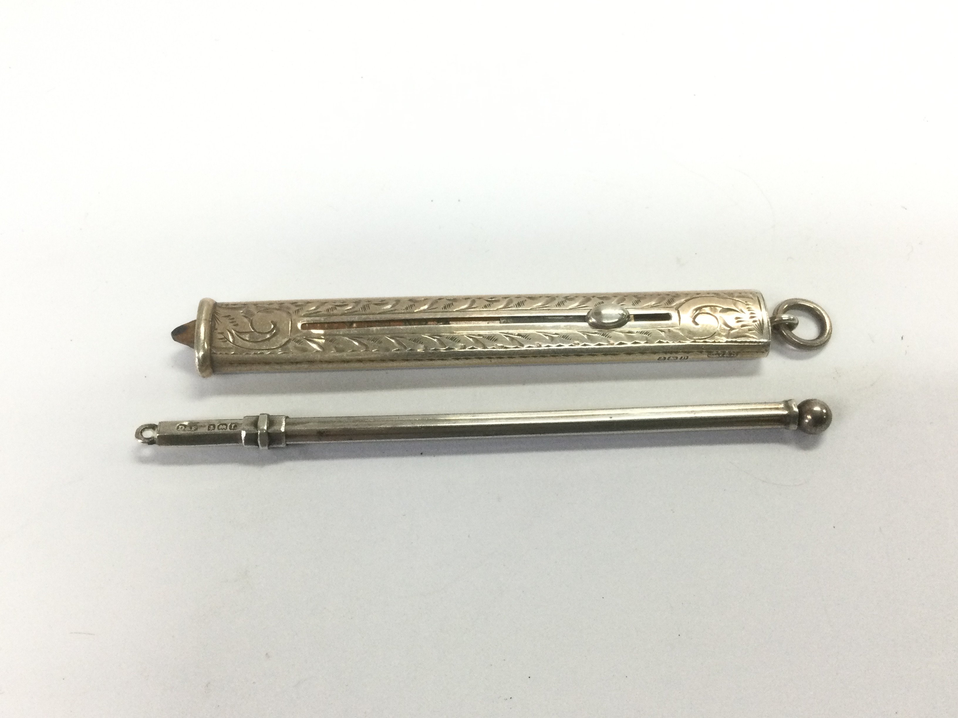 A silver propelling pencil and a silver swizzle stick (2). Shipping category A.