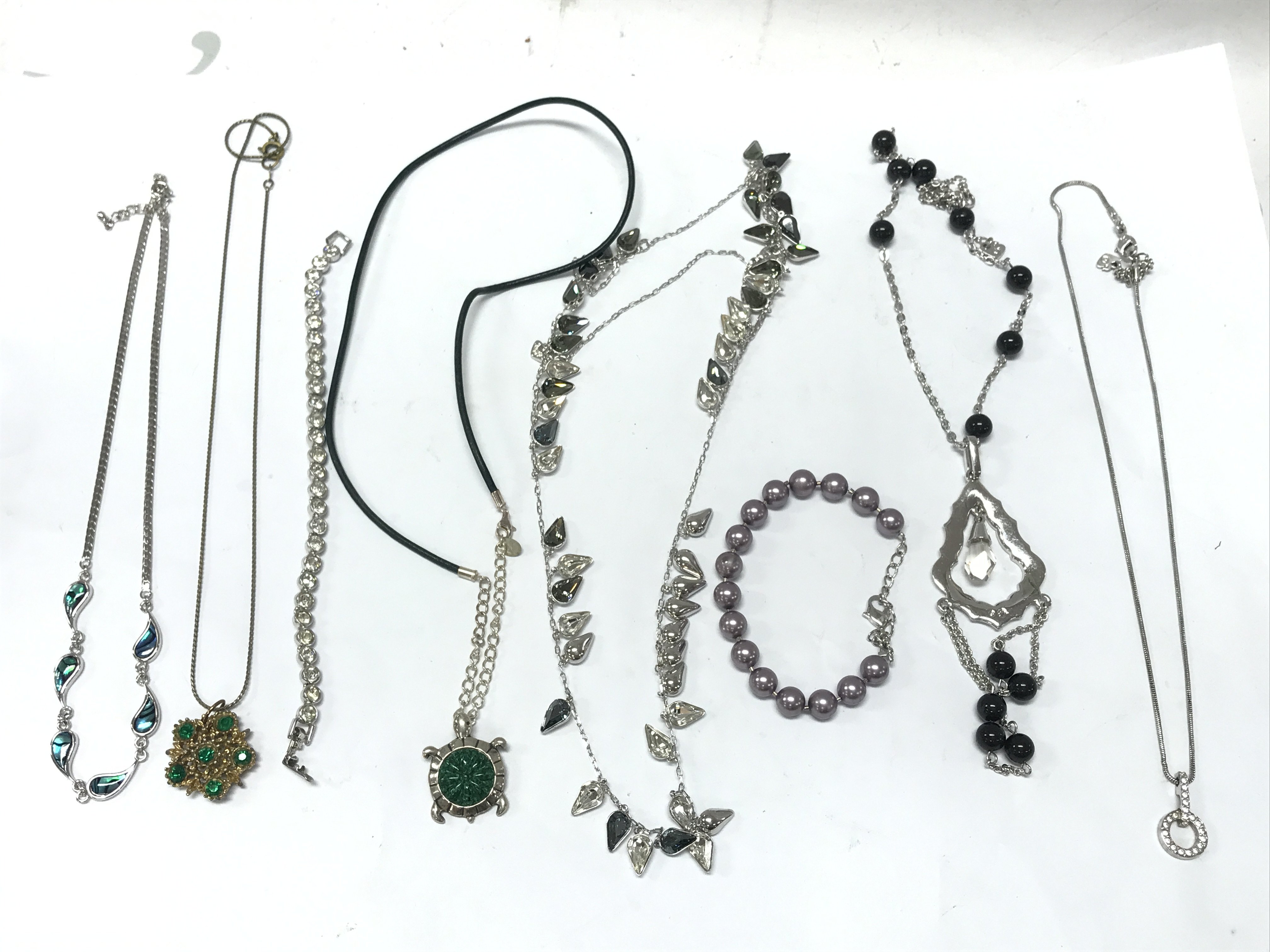 Silver coloured necklaces and bracelets with stones . Postage cat A