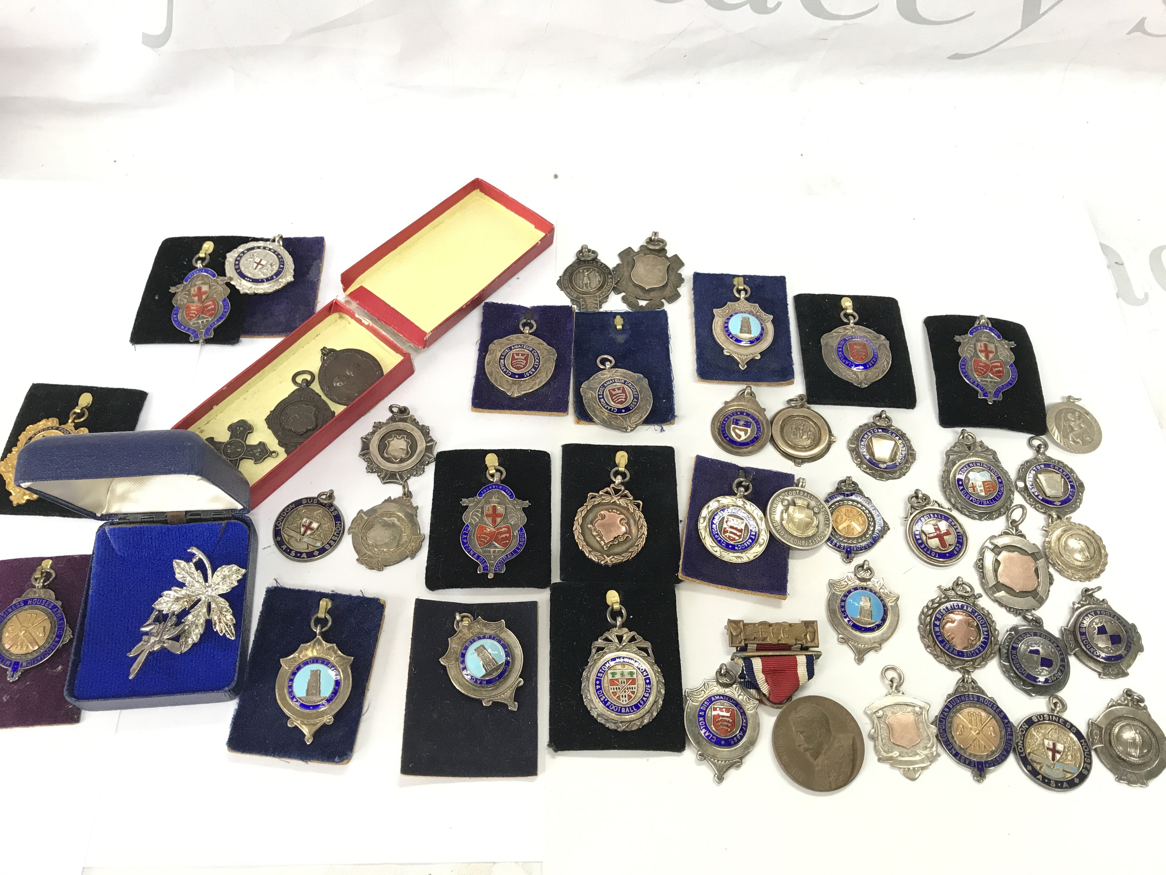 A large collection of pendant with the vast majority being silver.