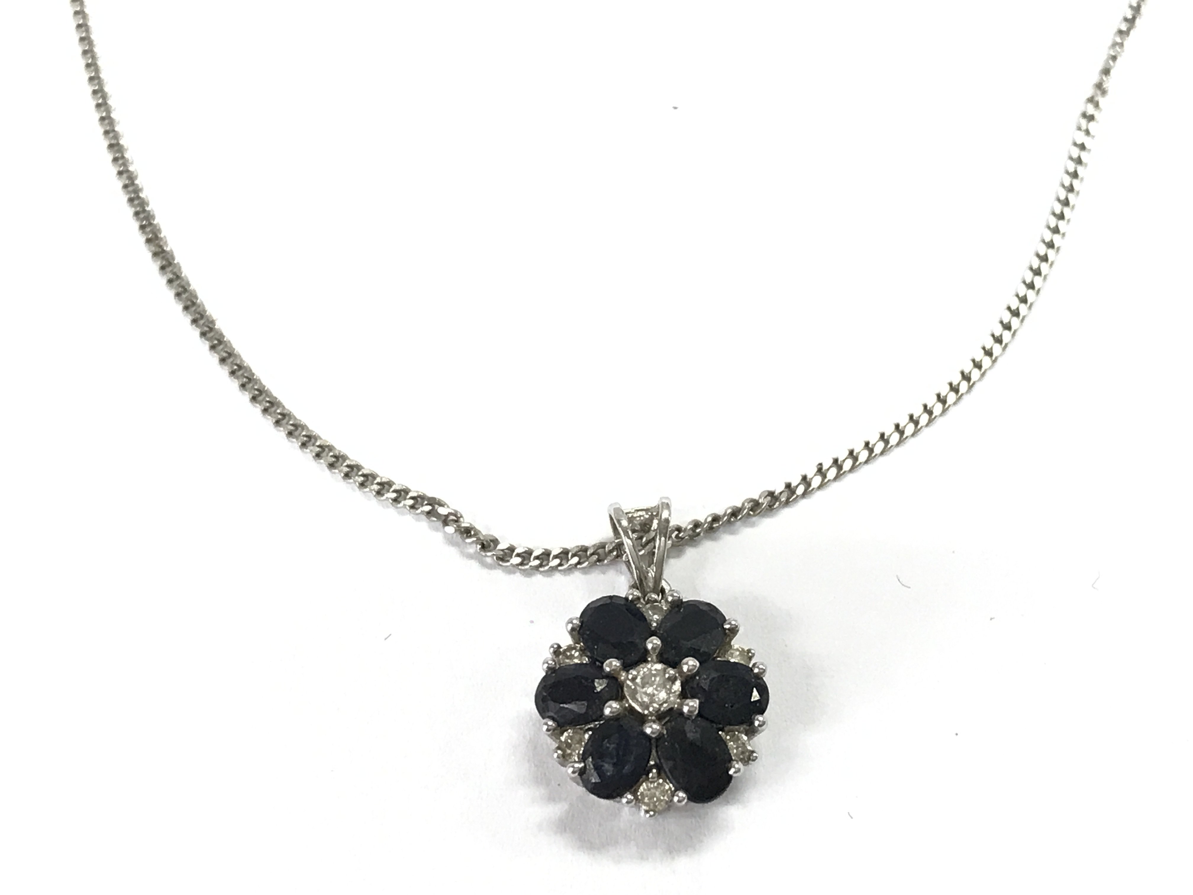 A 9ct white gold necklace with a sapphire set pendant. 3.36g Postage A