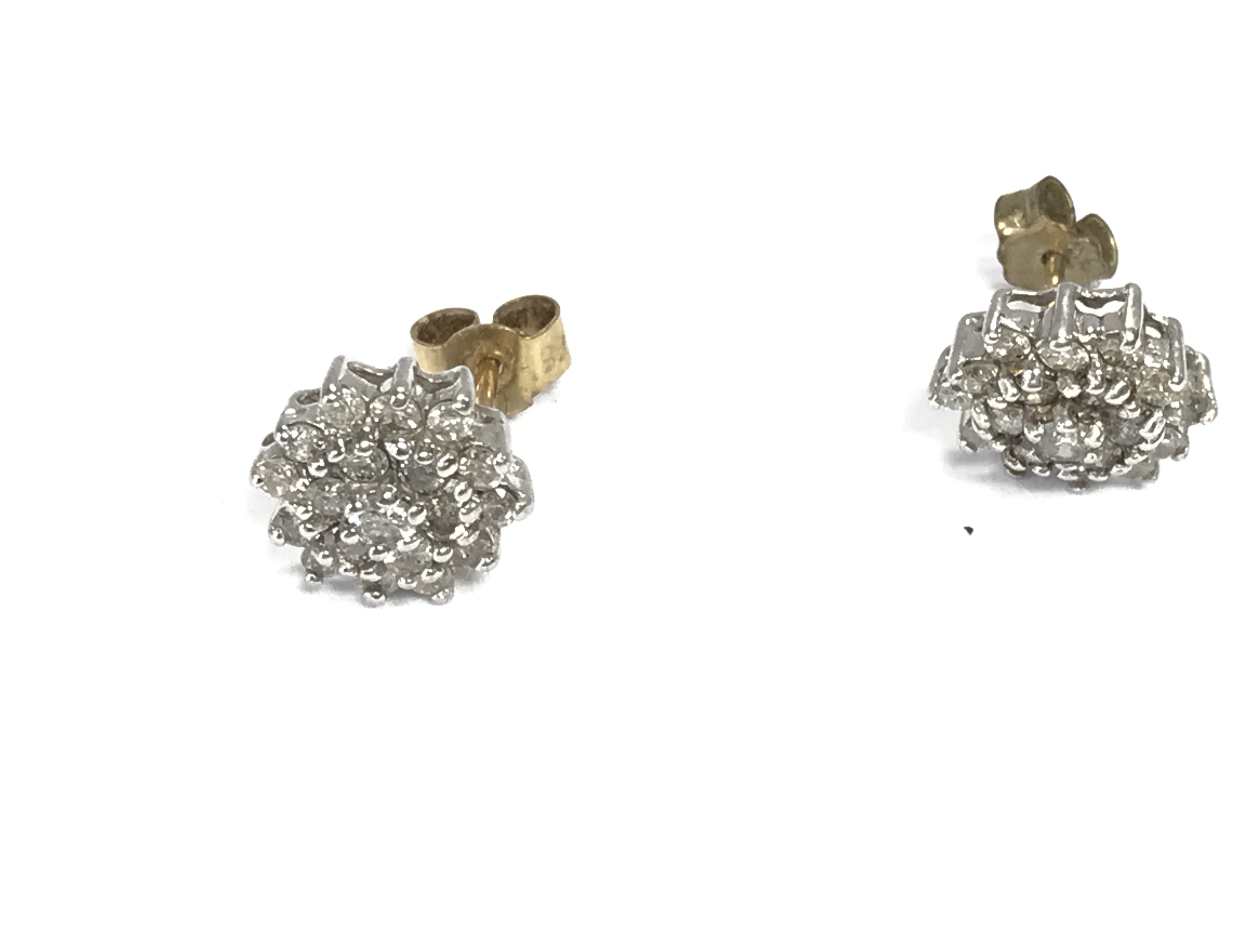 A pair of diamond cluster earrings. 2.56g Postage A