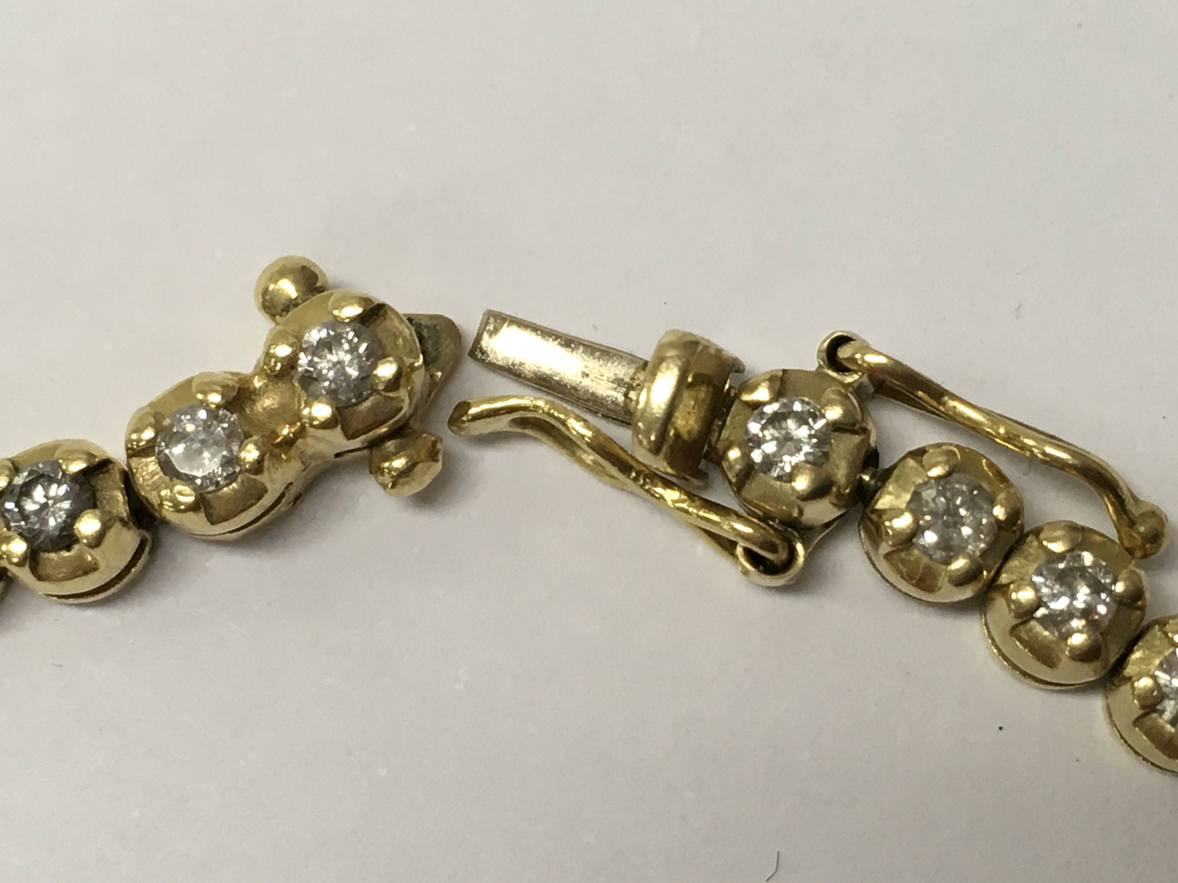 A 18ct yellow gold line bracelet inset with 51 diamonds.