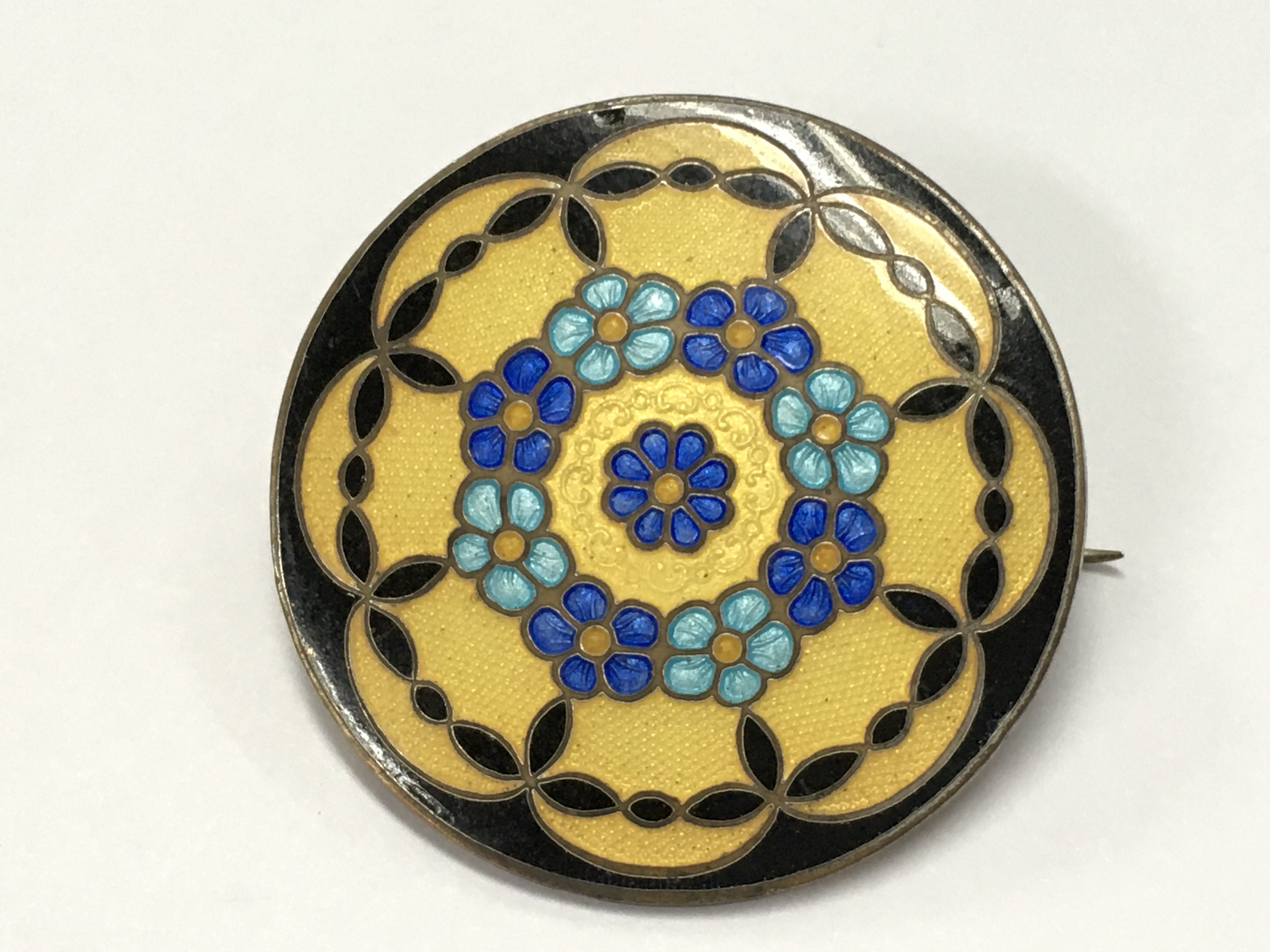 An unmarked enamel brooch , postage category A