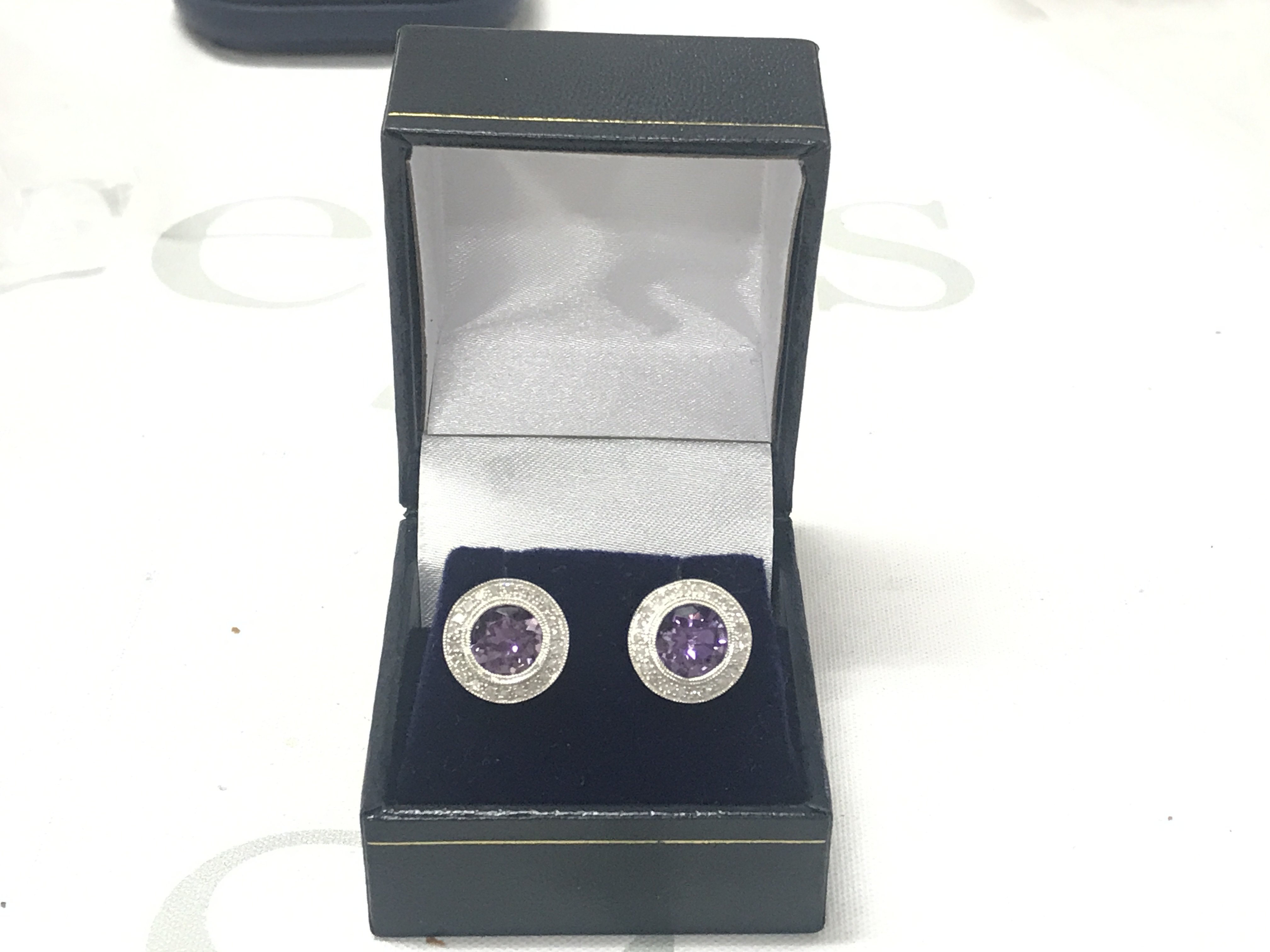 Pair of 9ct white gold cluster stud earrings set with round amethysts surrounded by RBC diamonds, boxed. Amethyst 2.20ct approx. Diamonds 0.40ct approx