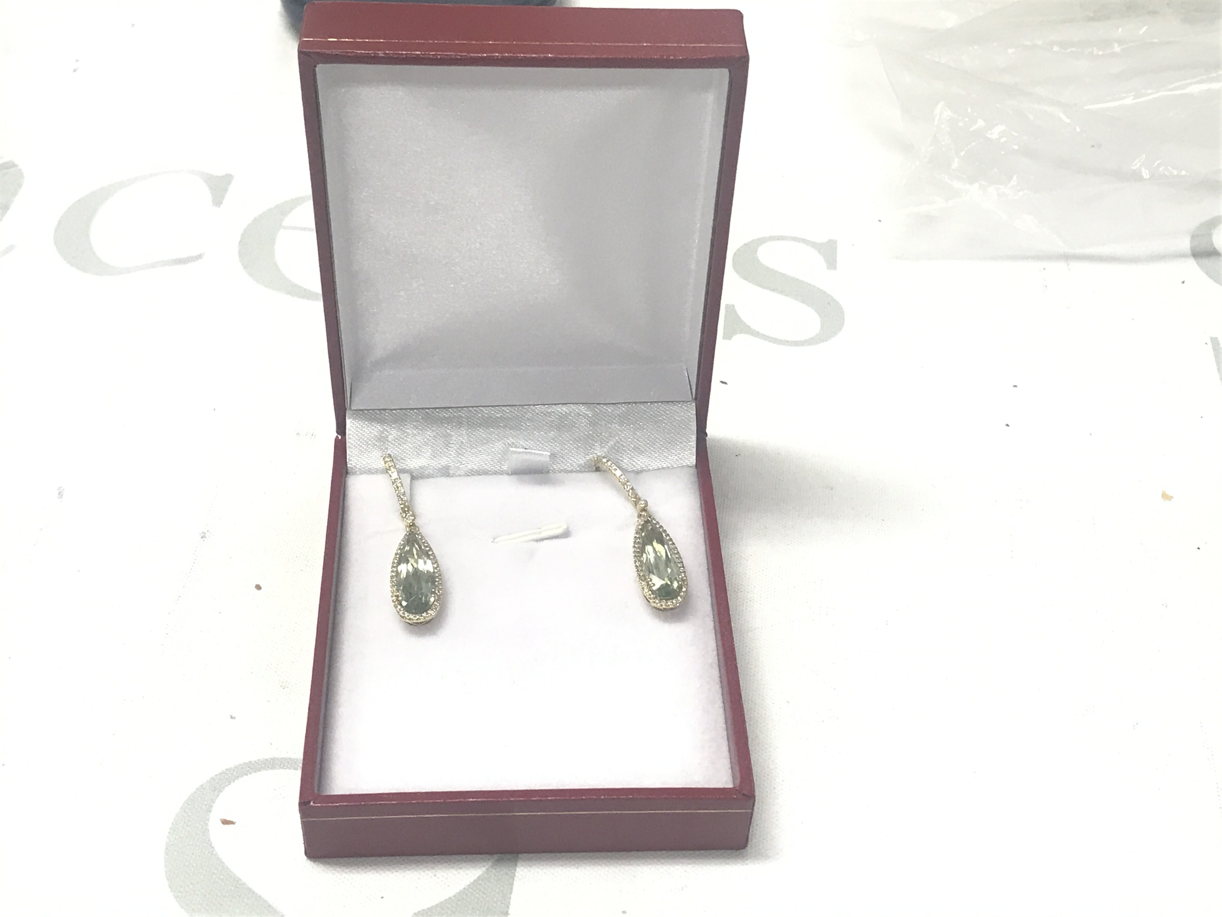 Pair of 9ct yellow gold long drop earrings set with pear shaped green amethysts surrounded by RBC diamonds, with further RBC diamonds to the bales and loops, boxed. Amethysts 6.62ct. Diamonds 0.45ct.