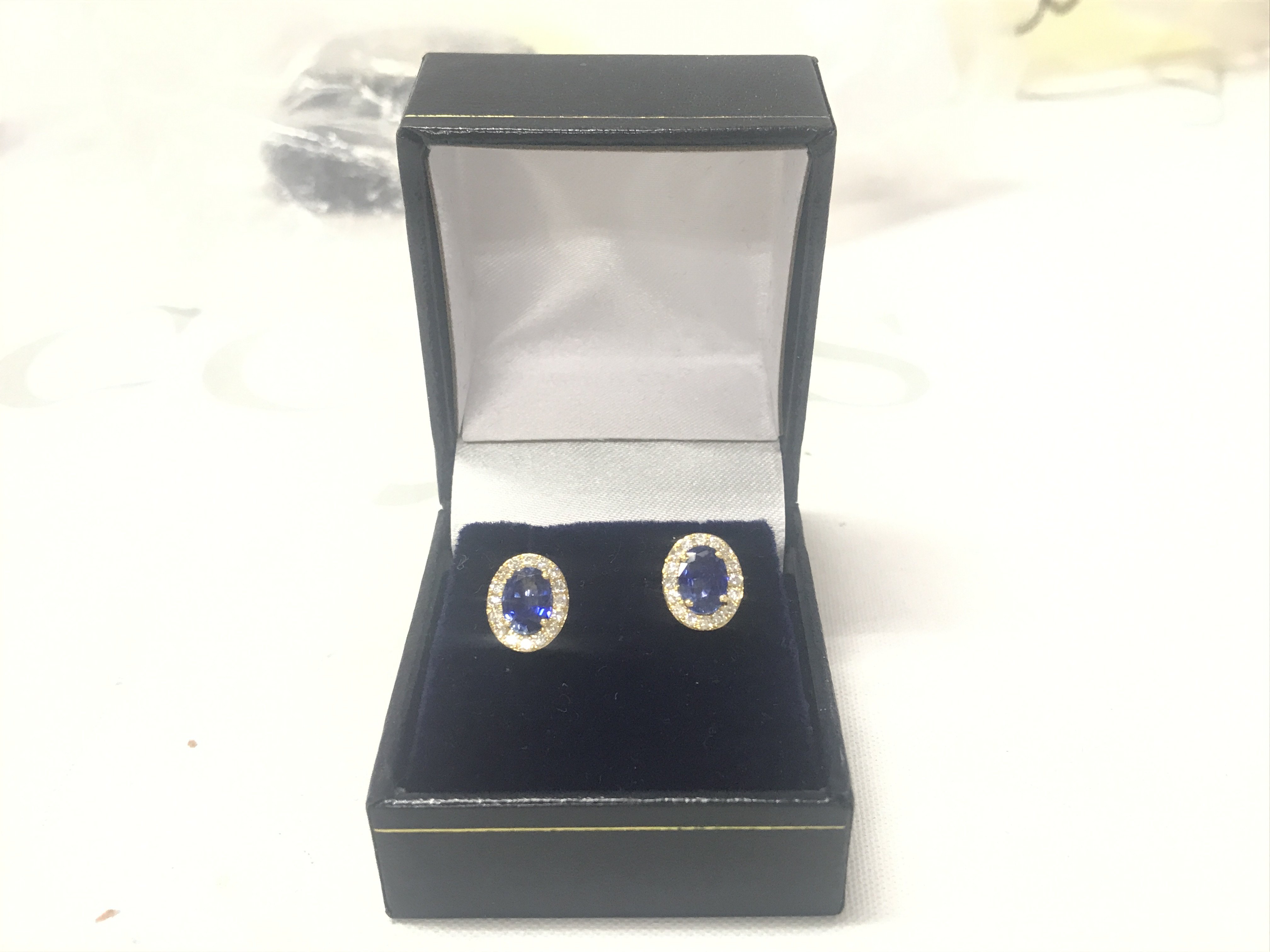Pair of 18ct yellow gold oval sapphire and RBC diamond cluster studs, boxed. Sapphires 2.00ct. Diamonds 0.36ct