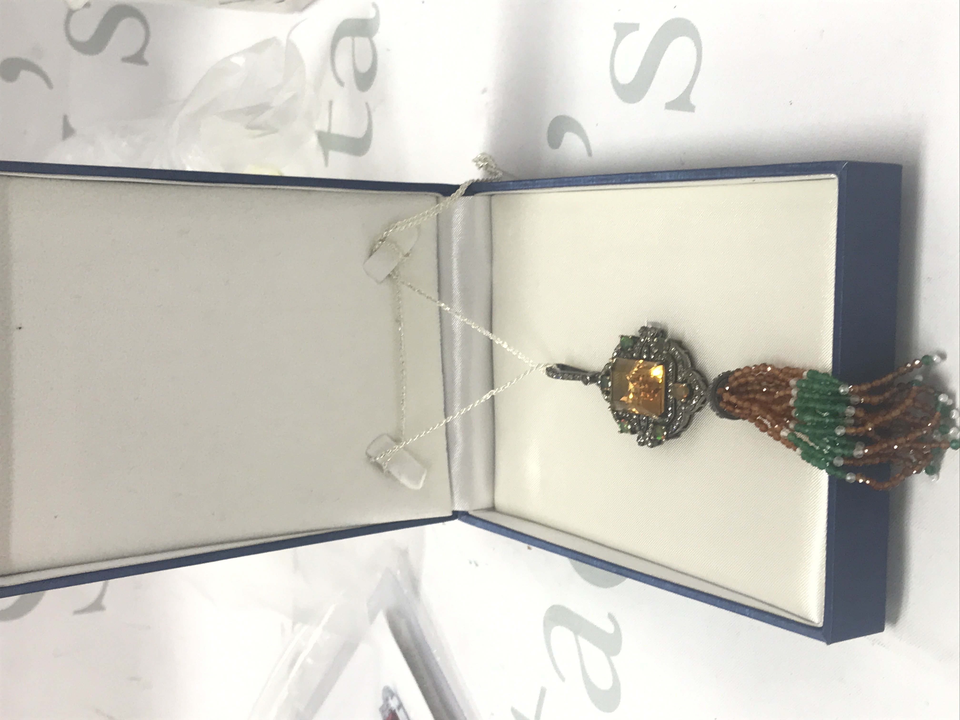 Large and exciting Jhumke-style pendant set with a large step-cut citrine, cabochon opals and diamonds, with beaded green onyx, crystal and malaya garnet in the tassle, on a silver chain. With a large box. Citrine 24.14ct. Opal 2.50ct. Diamonds 2.95ct.