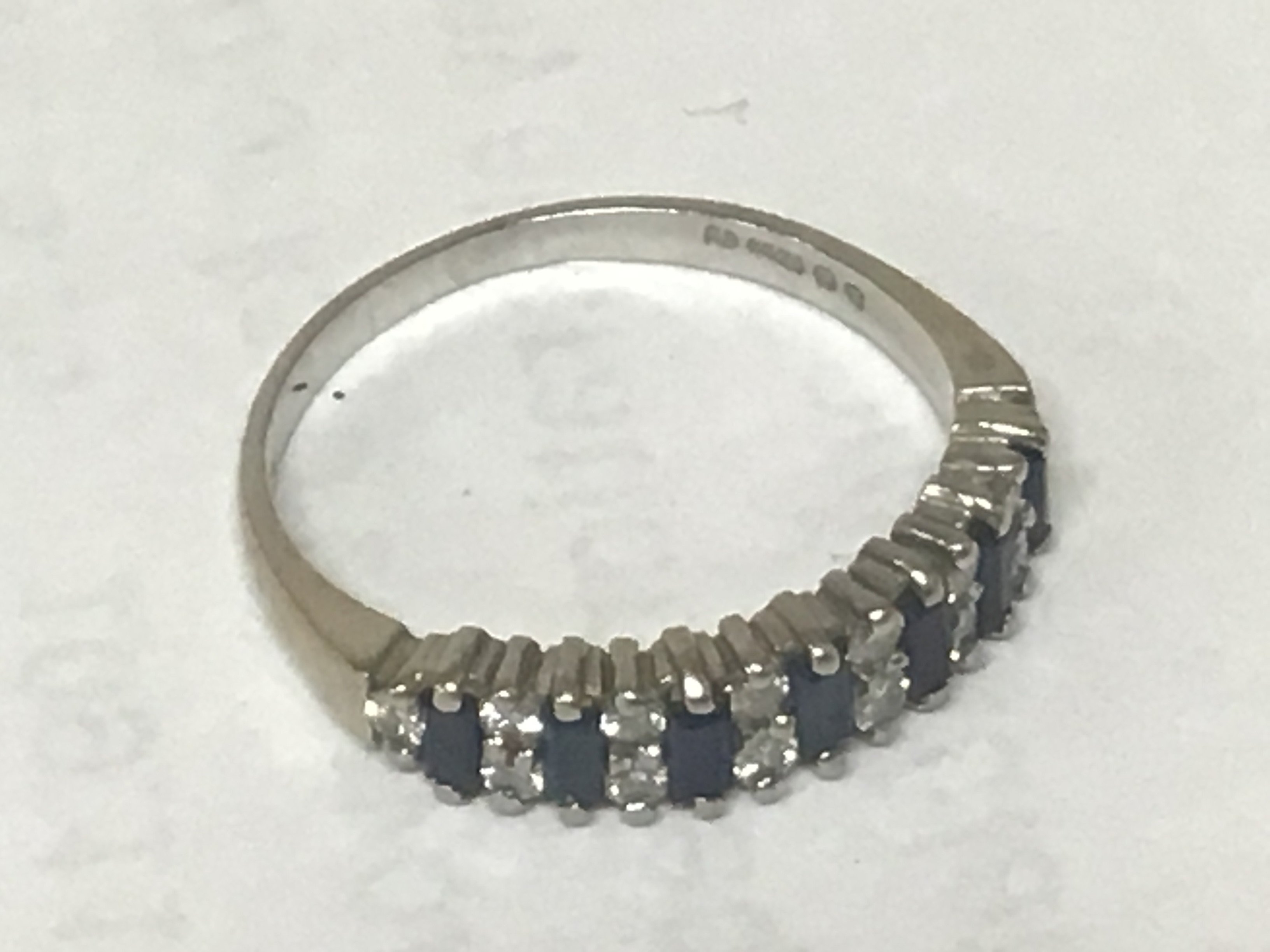An 18carat white gold ring set with sapphire and alternating diamonds. Weight 2.6g