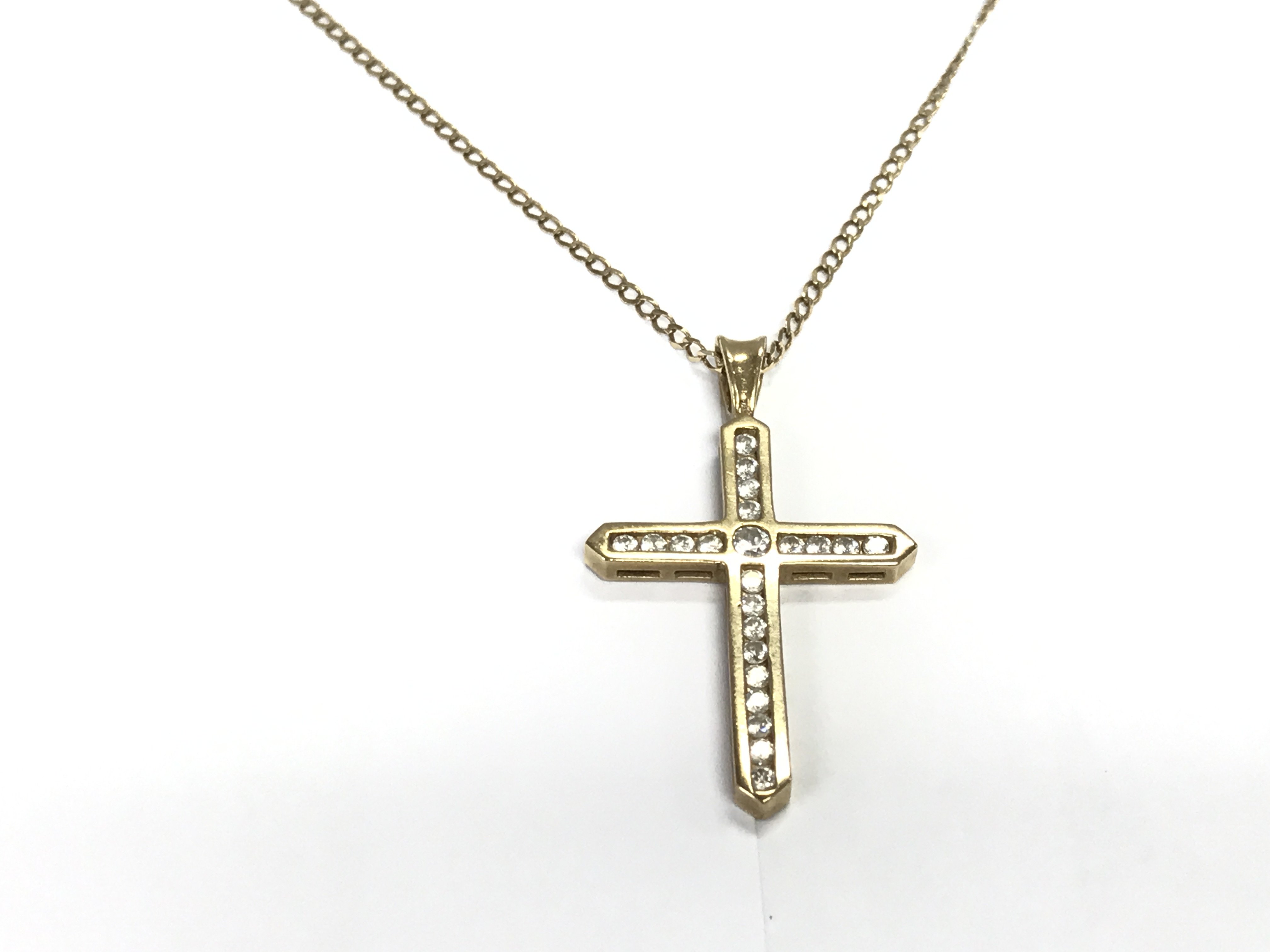 A 9ct gold cross and chain set with white stones. 4.24g