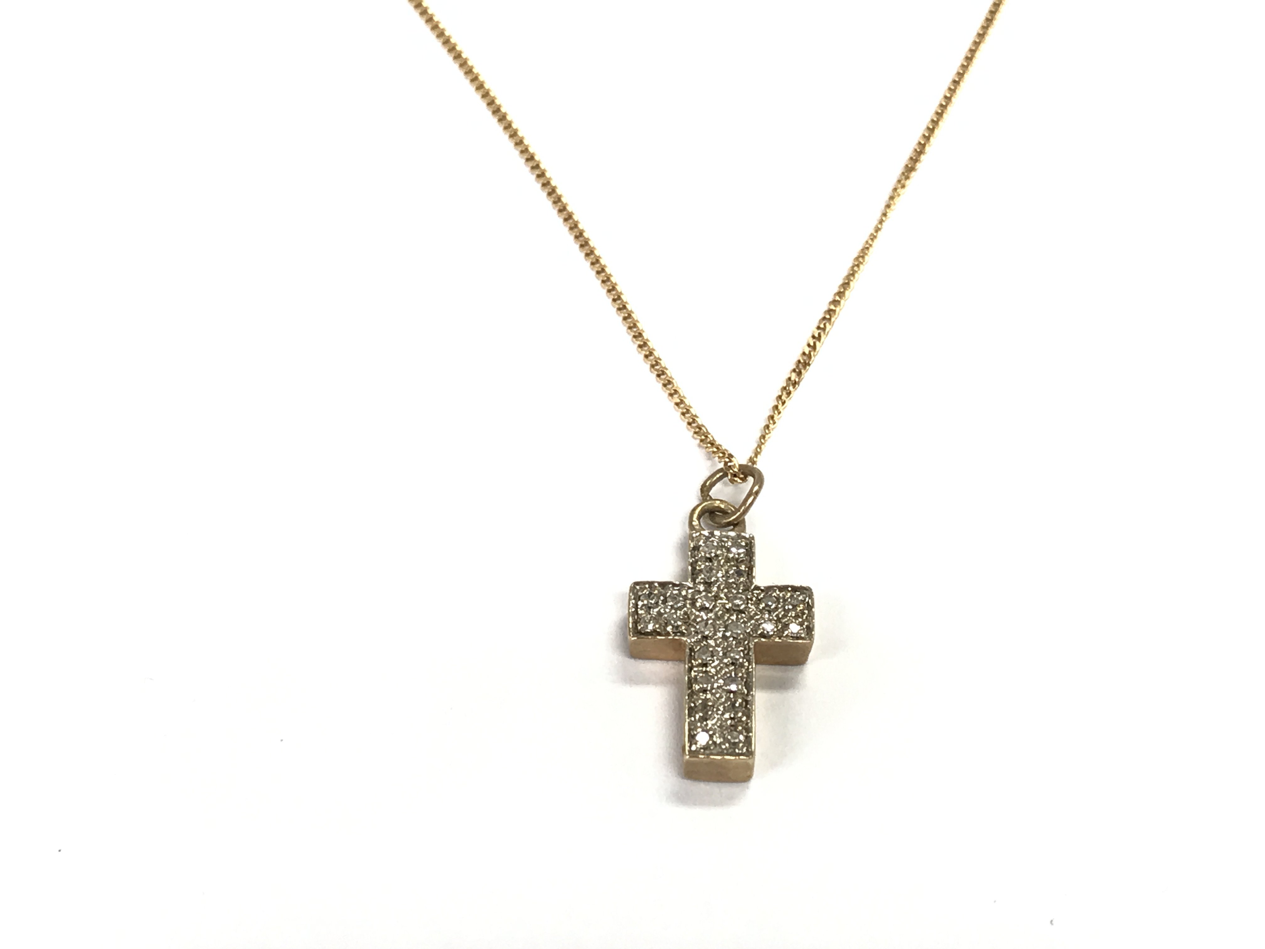 A 9ct gold chain with diamond set cross pendant. Postage A