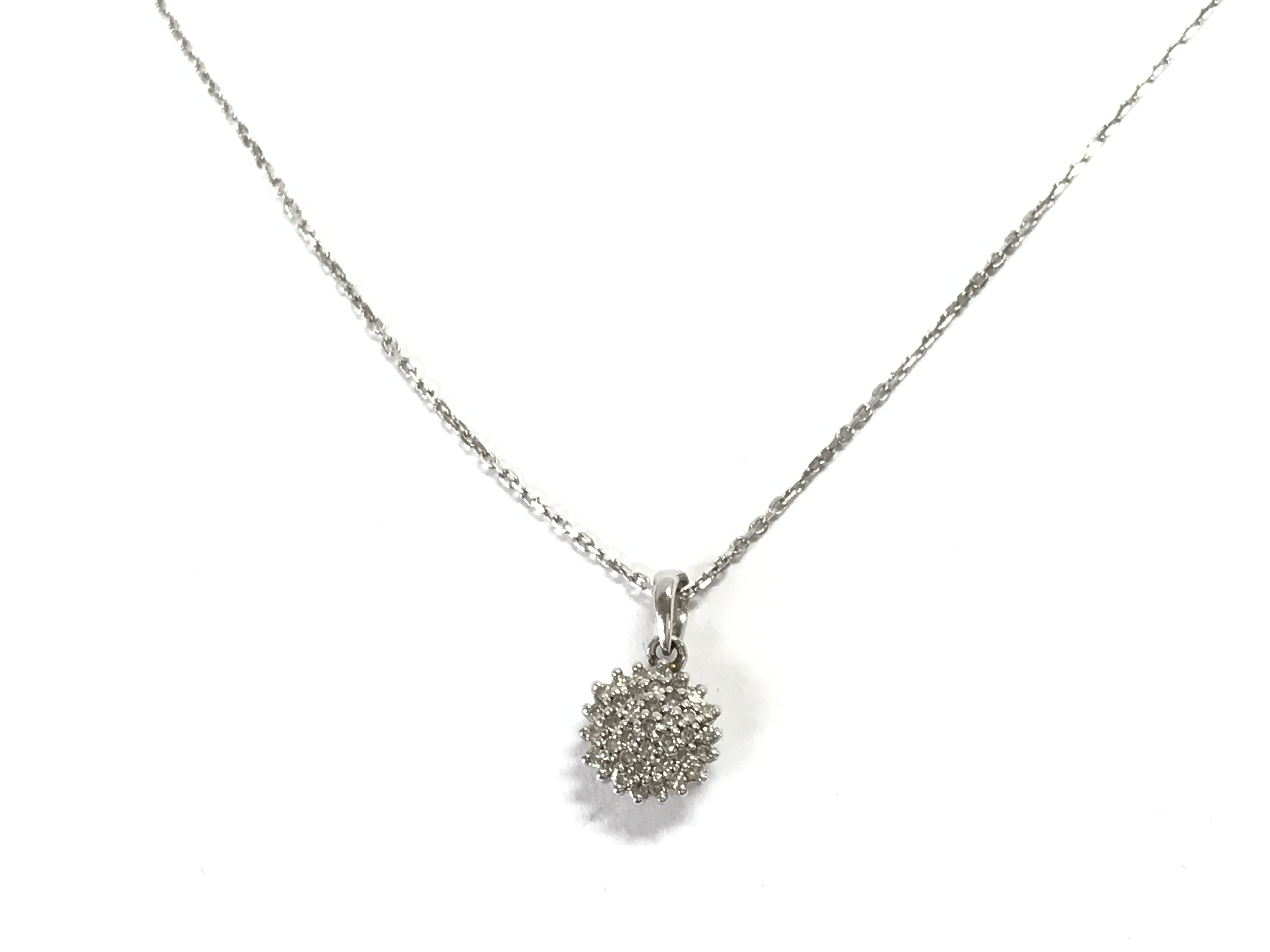 A 9ct white gold chain and diamond cluster pendant. 3.08g Postage A