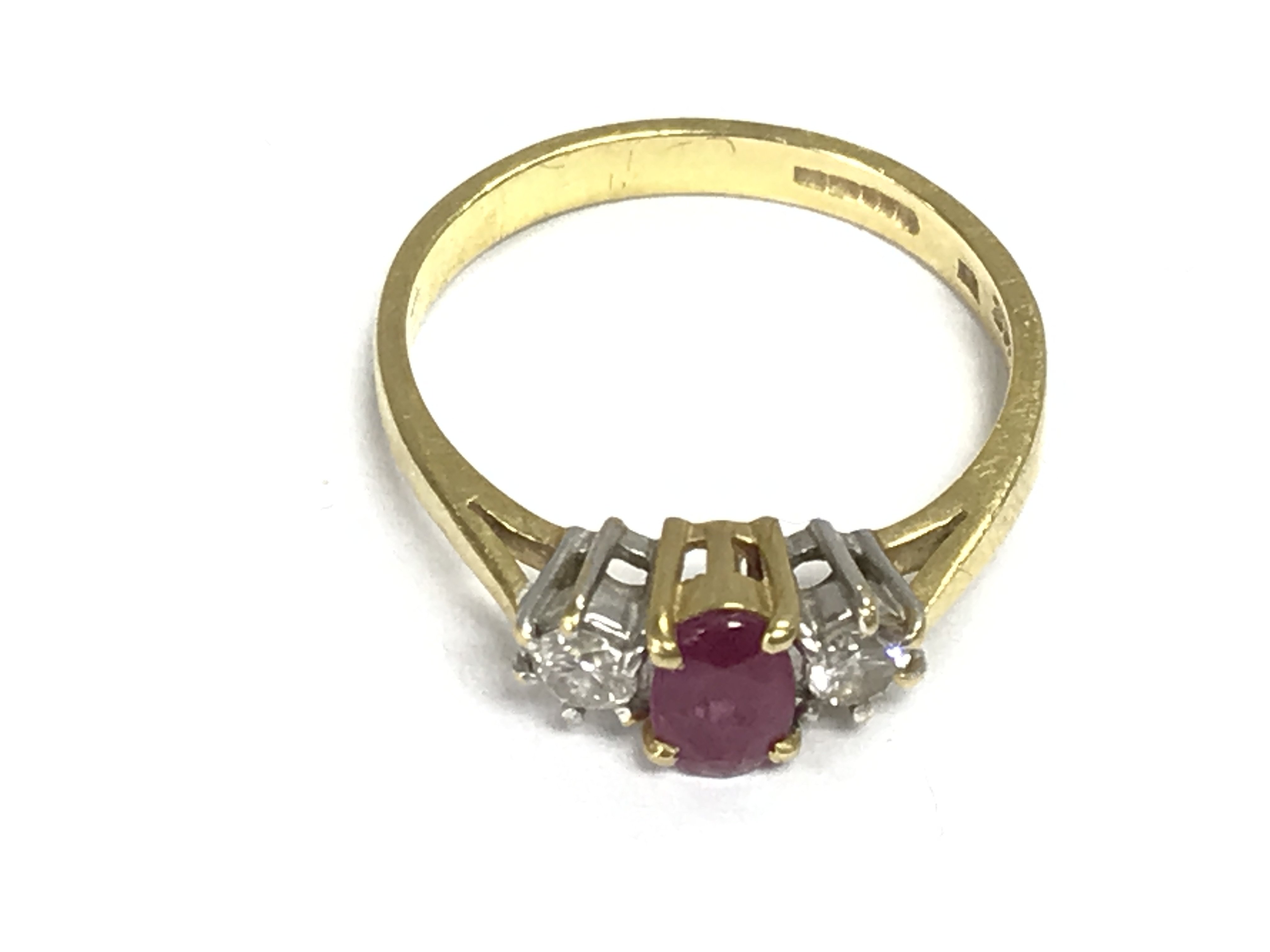An 18ct gold ring set with Ruby and diamonds. Size O and 3.03g