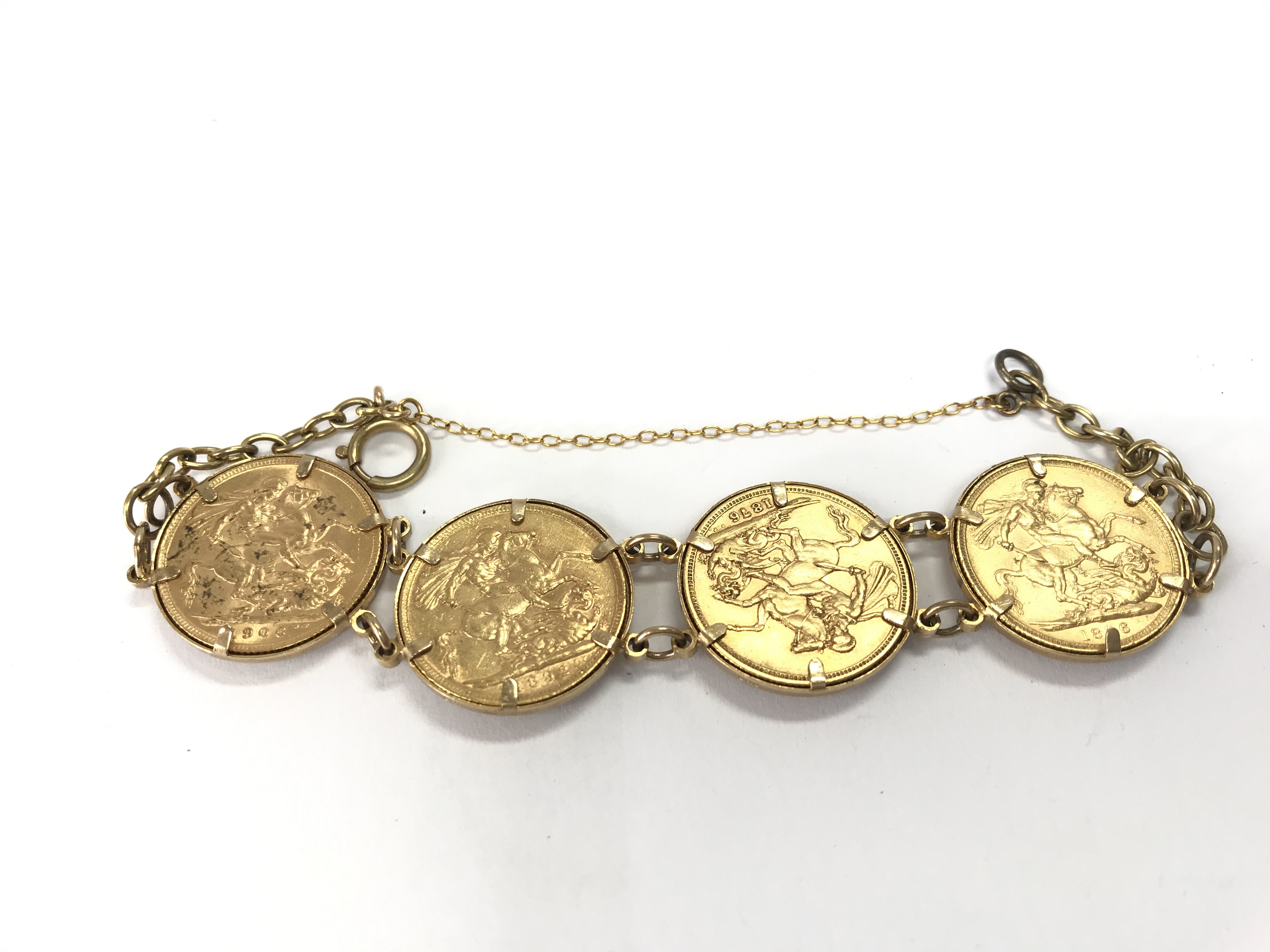 A 9ct gold bracelet containing four full sovereigns 1876 1892 1896 and 1906. 39.28g Postage B