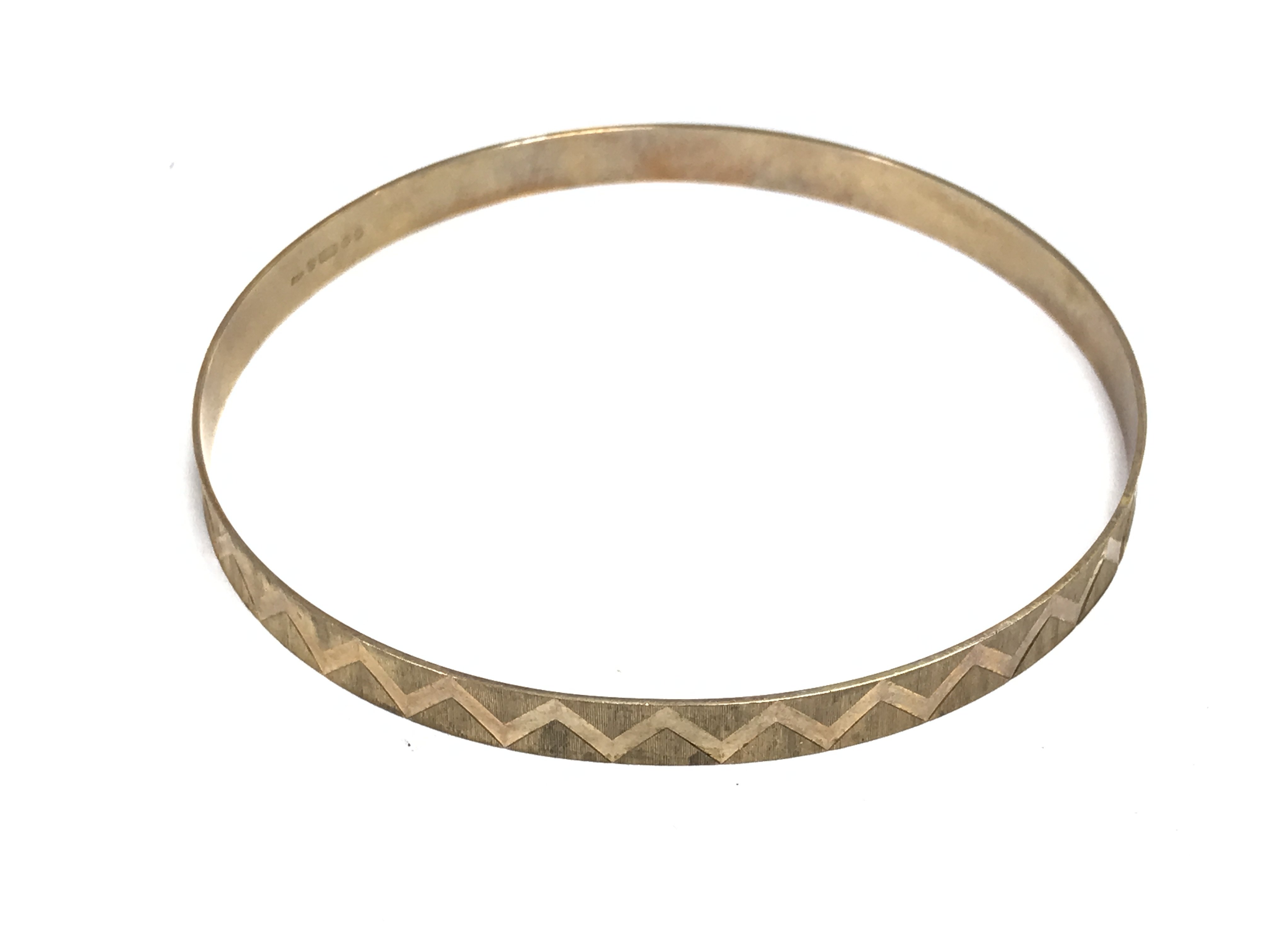 A 9ct gold bangle. Approximately 7cm diameter and 8.51g Postage A