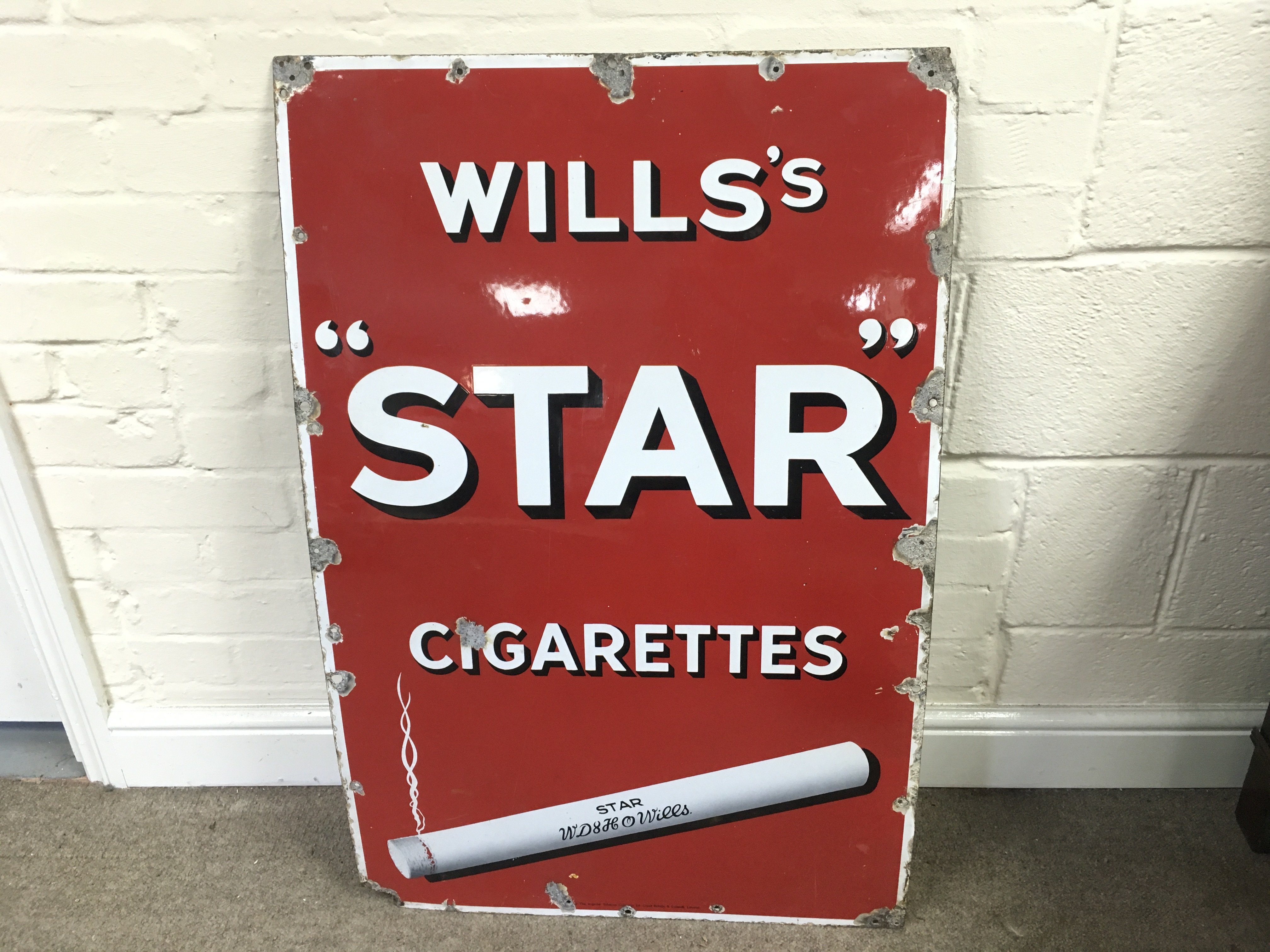 A Wills star cigarettes advertising sign24 x 37 inches approximately
