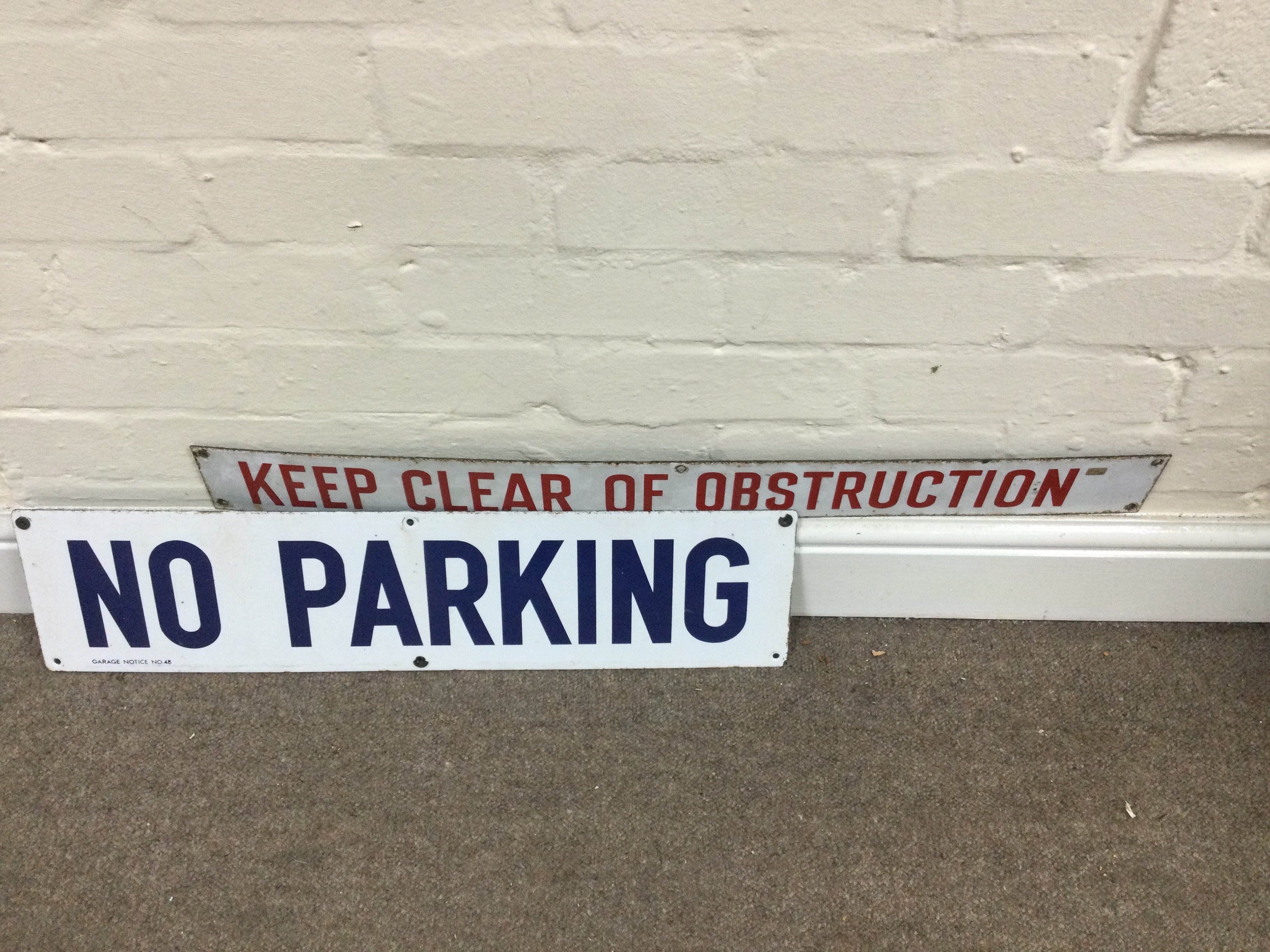 A no parking and a keep clear of obstruction signs. 6 x 25 inches approximately 3 x 30 inches approximately