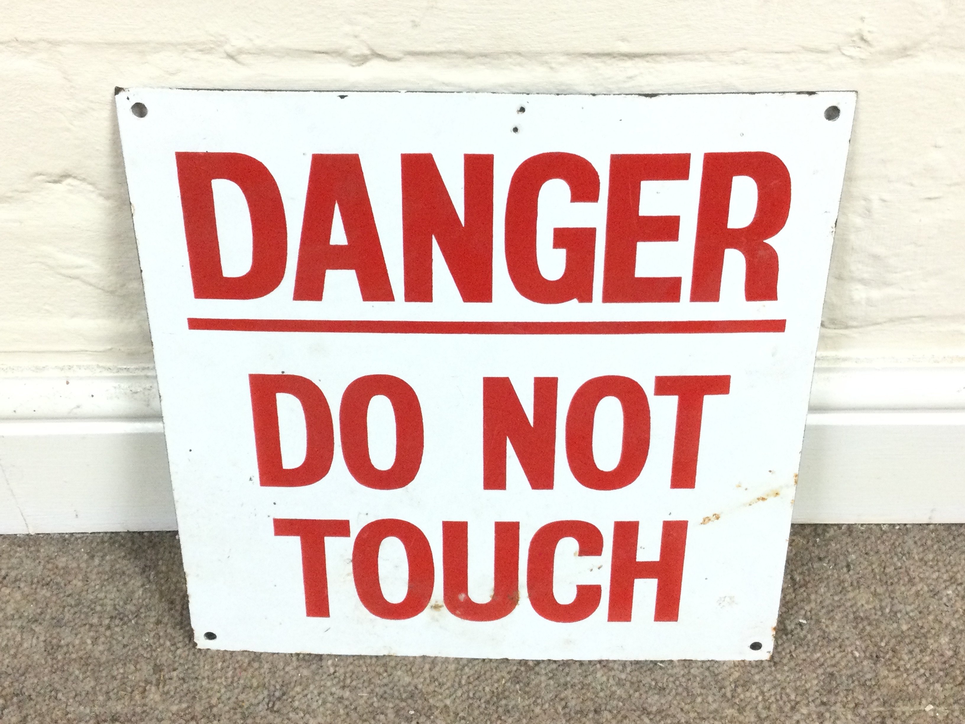 A danger do not touch enamel sign. 12 x 12 inches