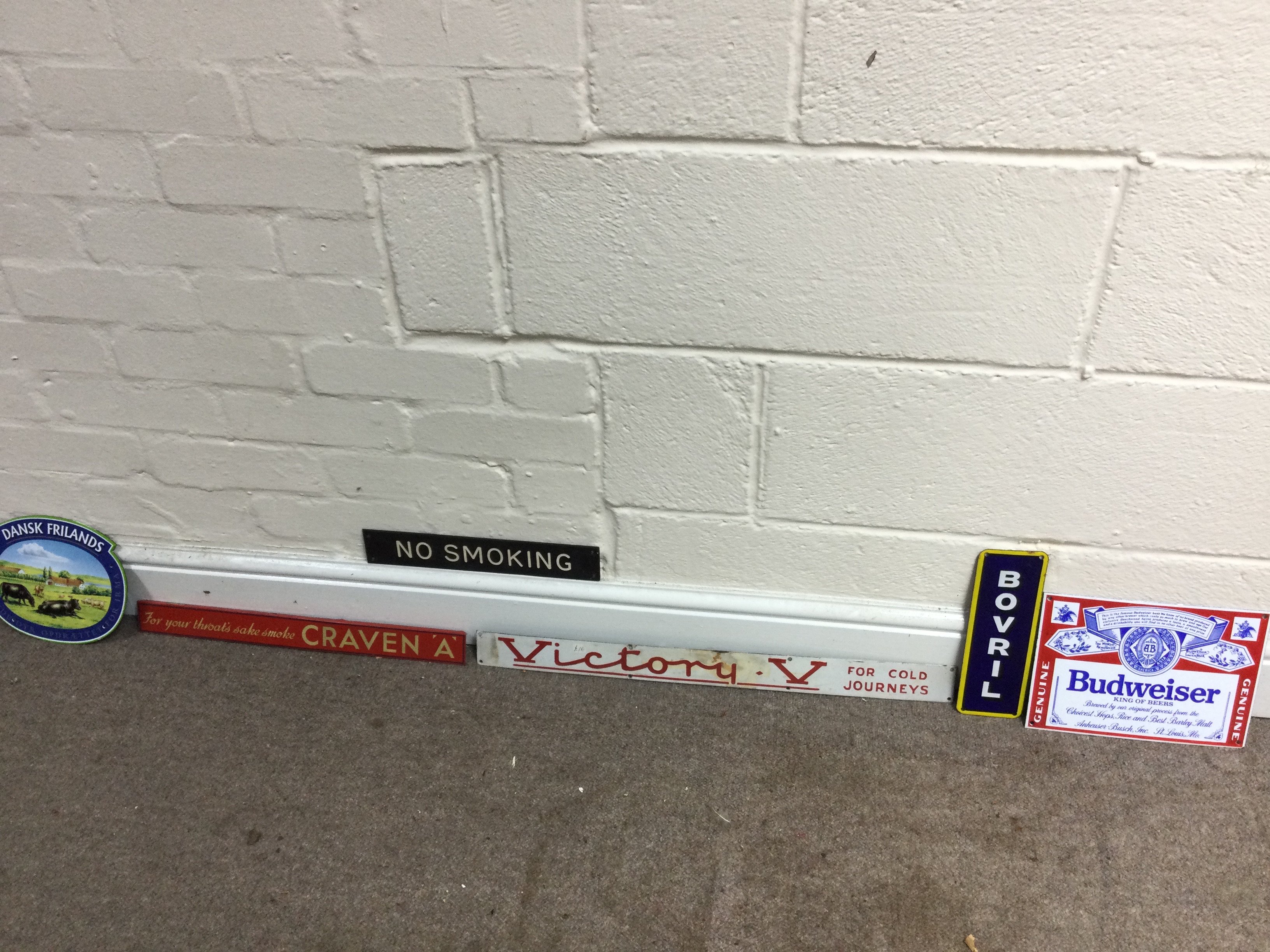 A collection of assorted small advertising signs including bovril and craven A