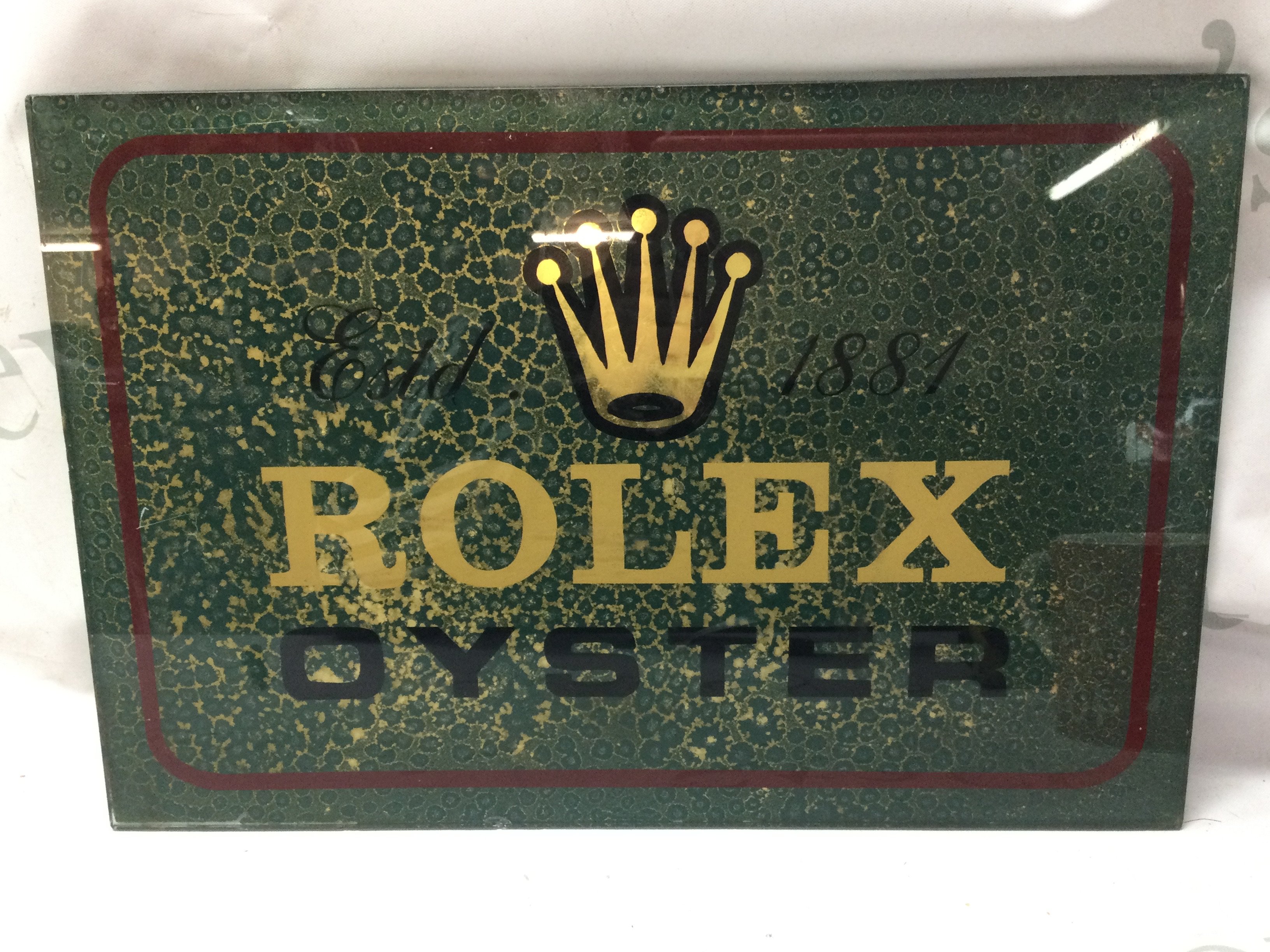 A vintage glass Rolex Oyster advertising sign dimensions 38x26cm. This lot cannot be posted