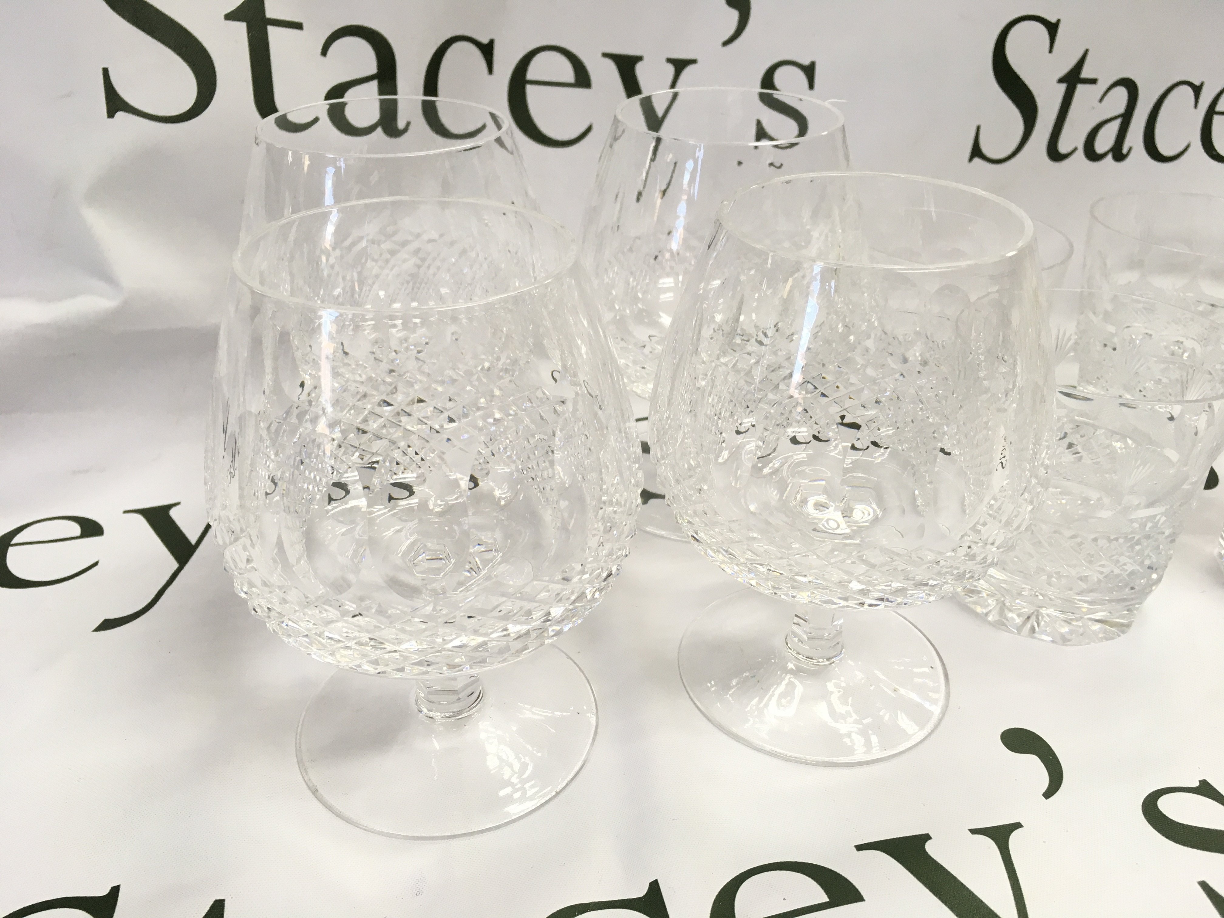 A collection of assorted glasses including 8 Waterford crystal glasses. Postage D