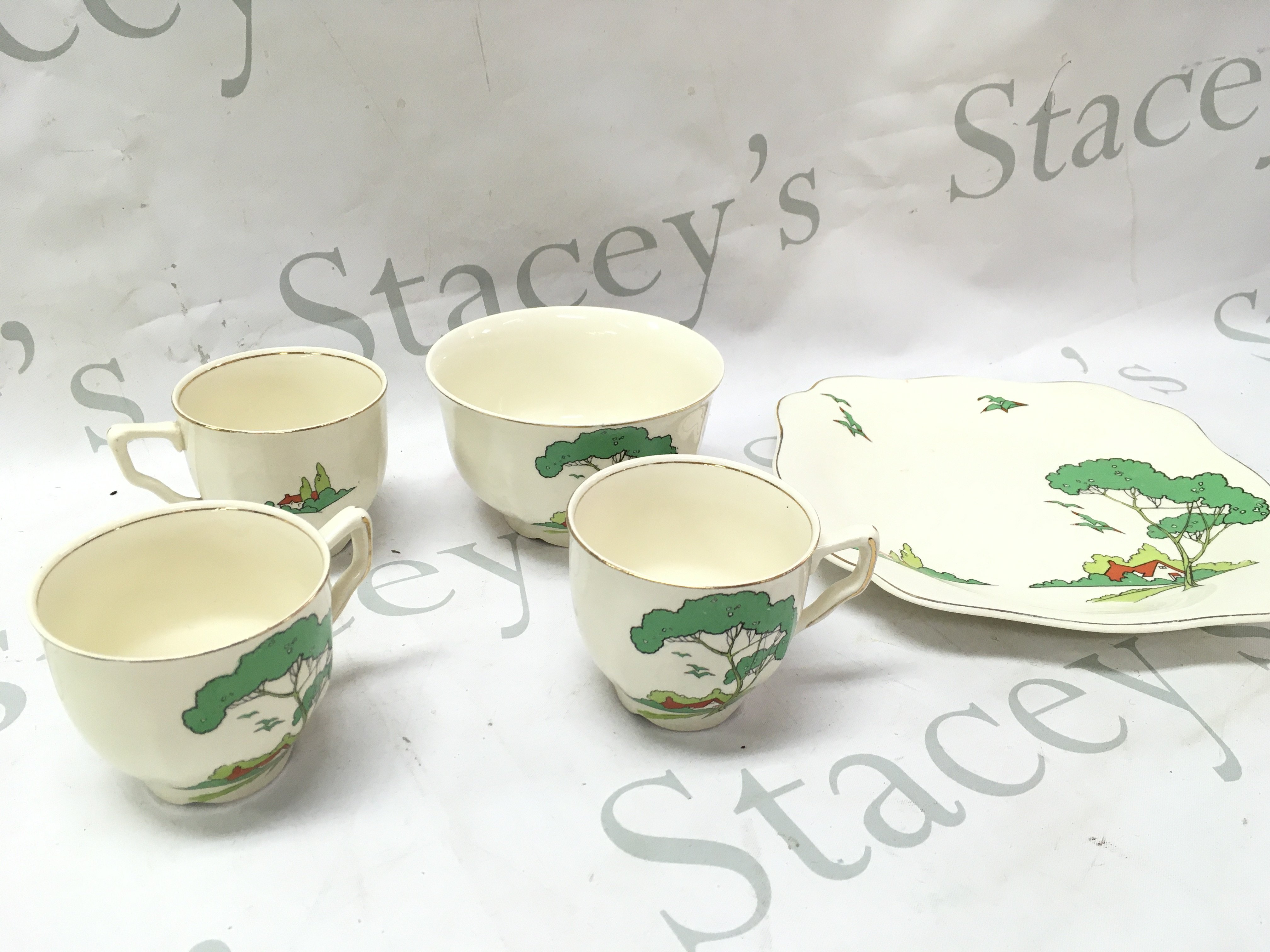 A Clarice cliff Snow White style tea set including saucers , cups, bowl dish and a Crown Devon jar. This lot cannot be posted